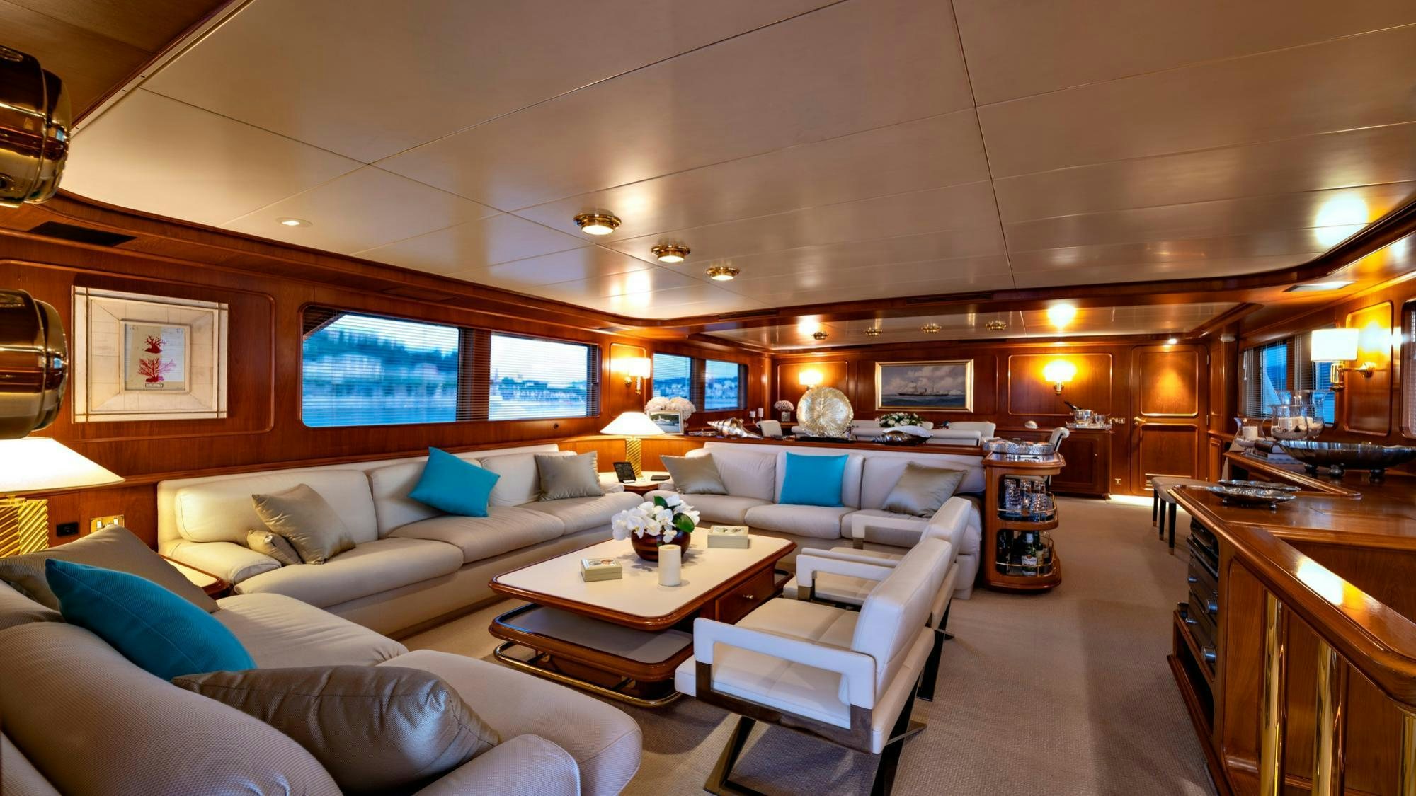 a room with a couch and a table and chairs aboard NIGHTFLOWER Yacht for Charter