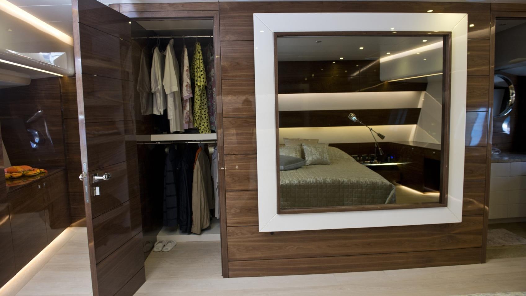 a closet with a bed and a mirror aboard MUSIC Yacht for Charter