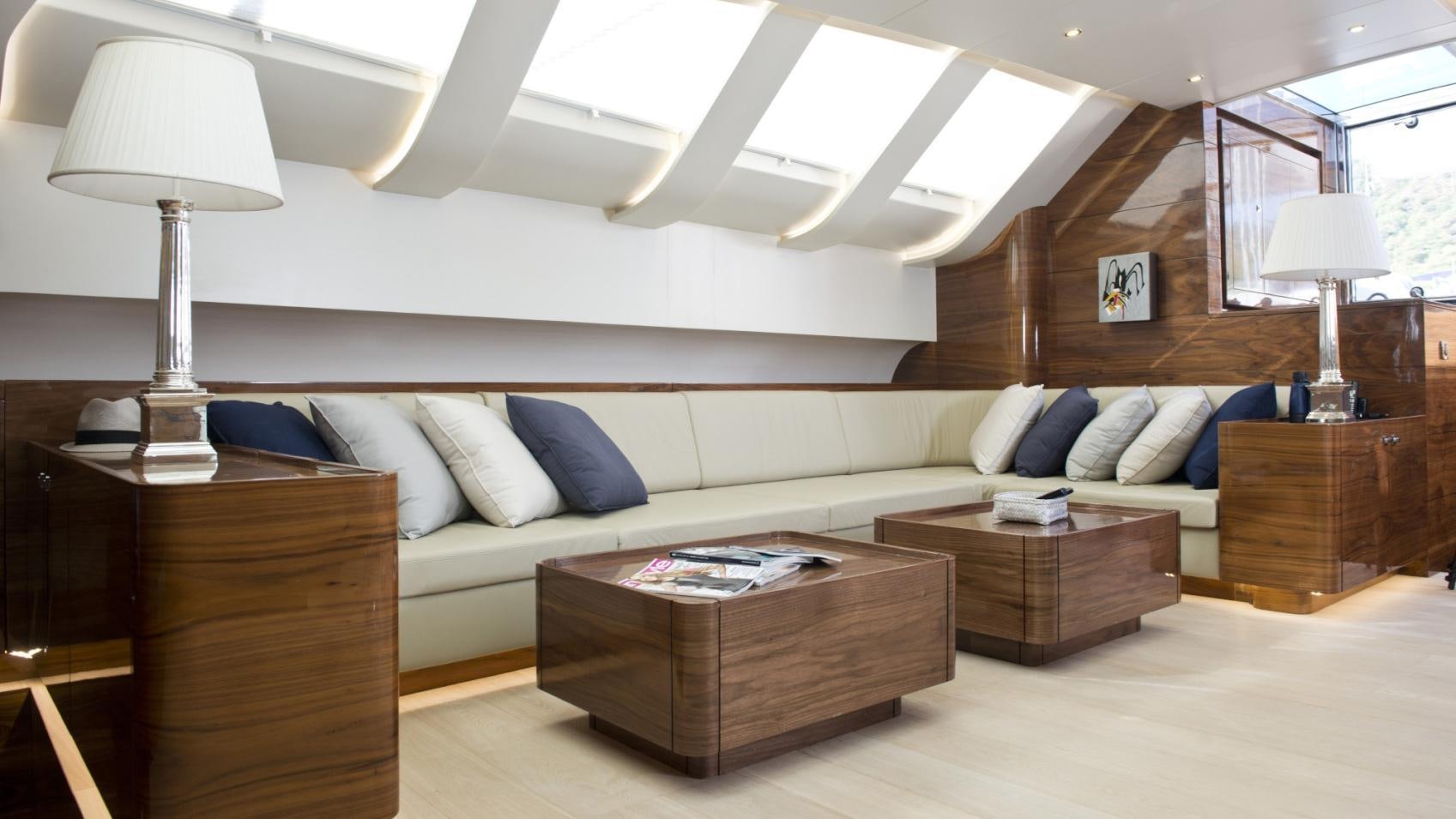 a living room with a couch and a coffee table aboard MUSIC Yacht for Charter
