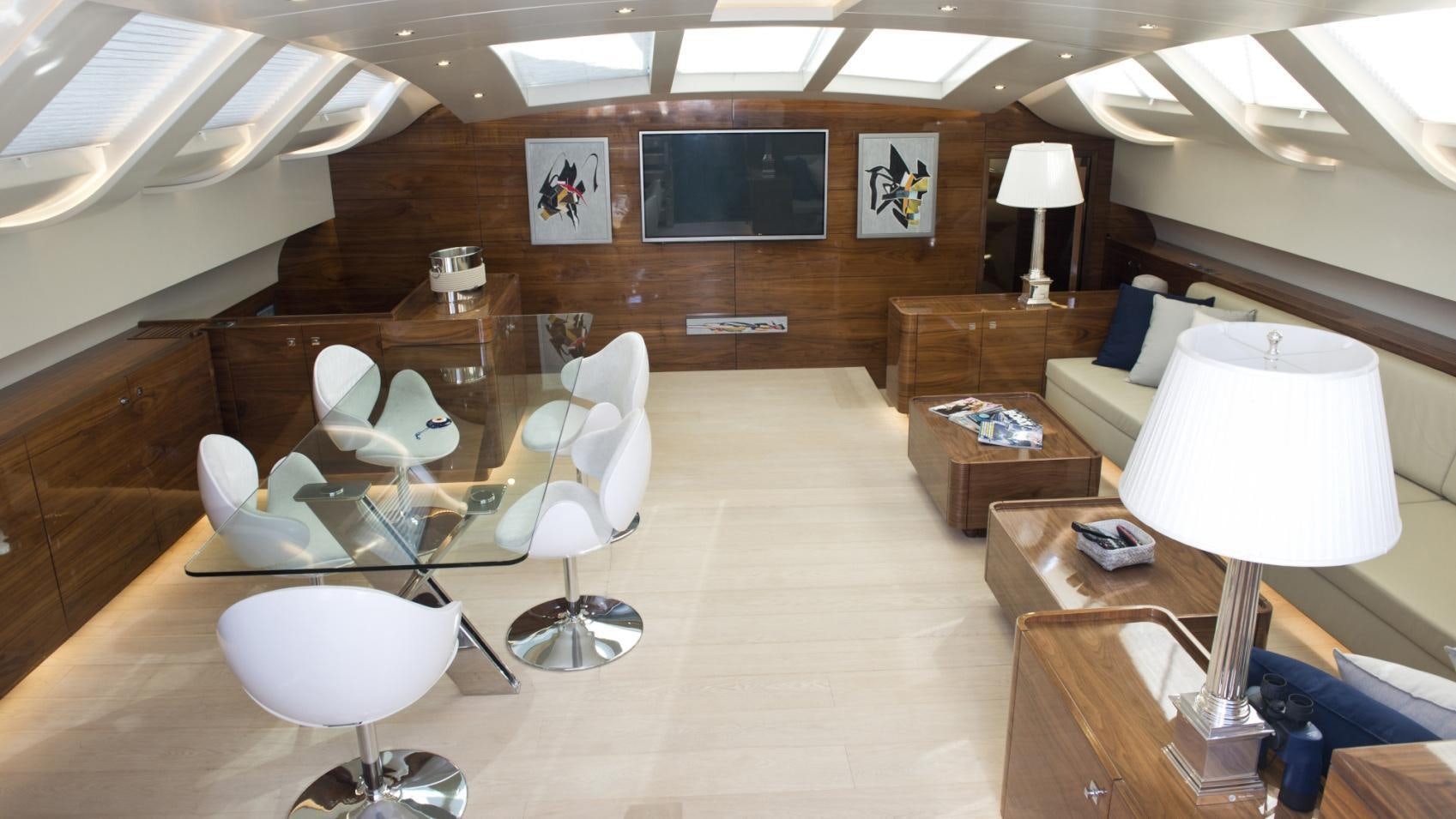 a room with a couch and a table and chairs aboard MUSIC Yacht for Charter