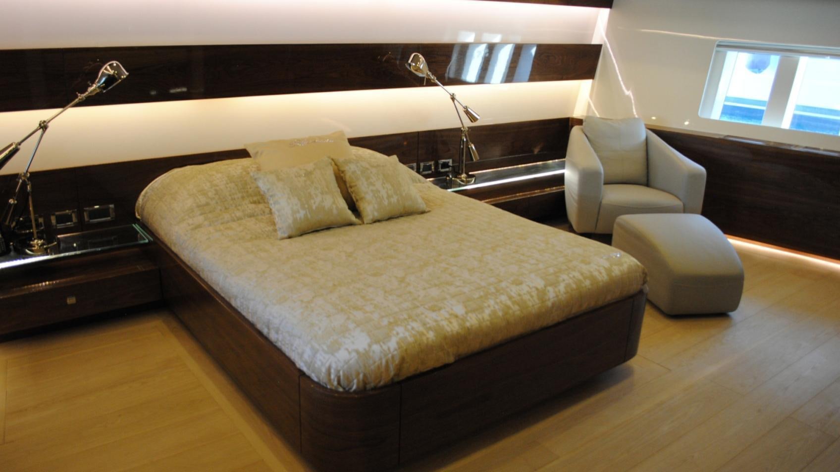 a bed with a white sheet aboard MUSIC Yacht for Charter