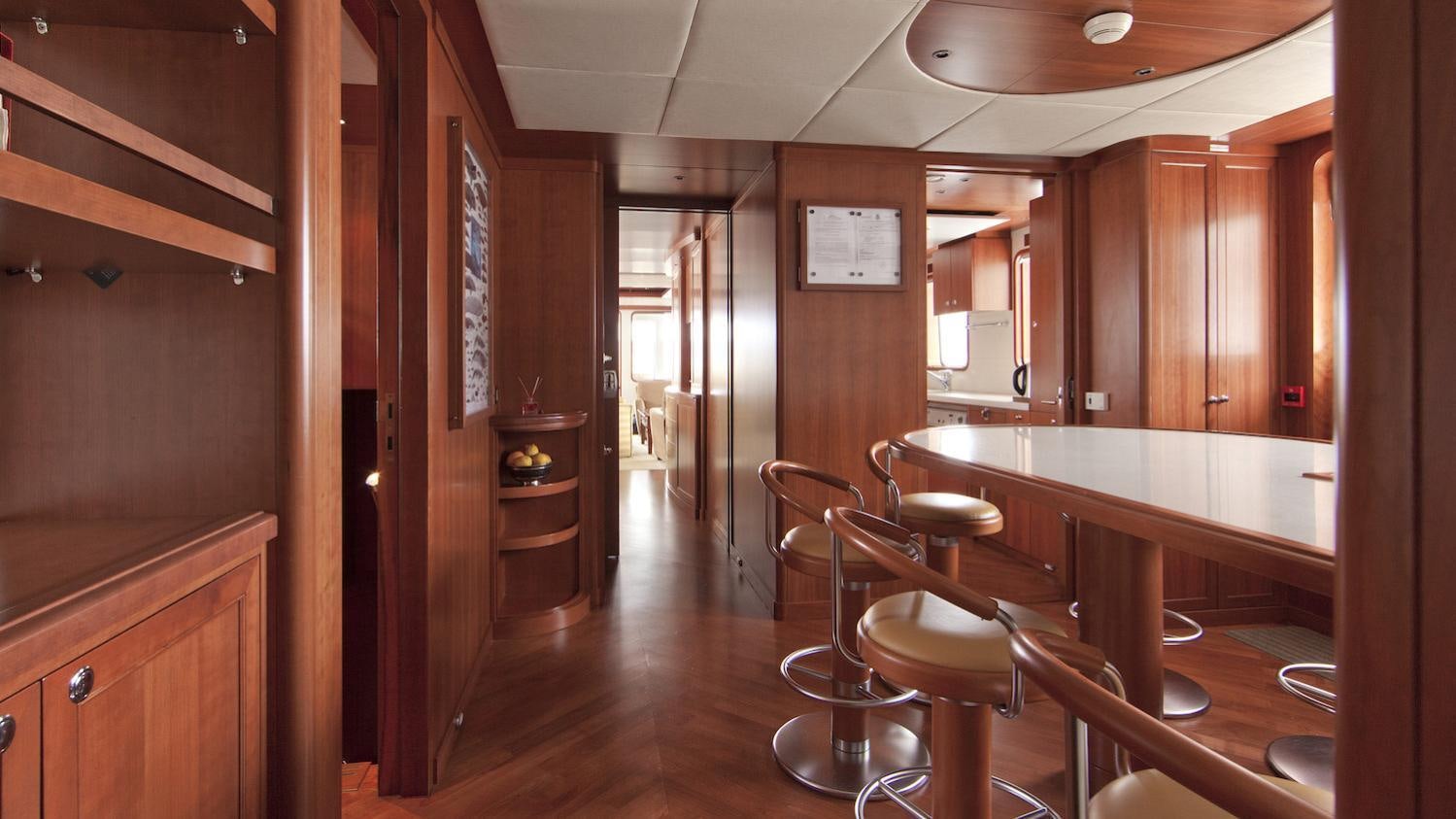 a kitchen with wooden cabinets aboard CORNELIA Yacht for Charter