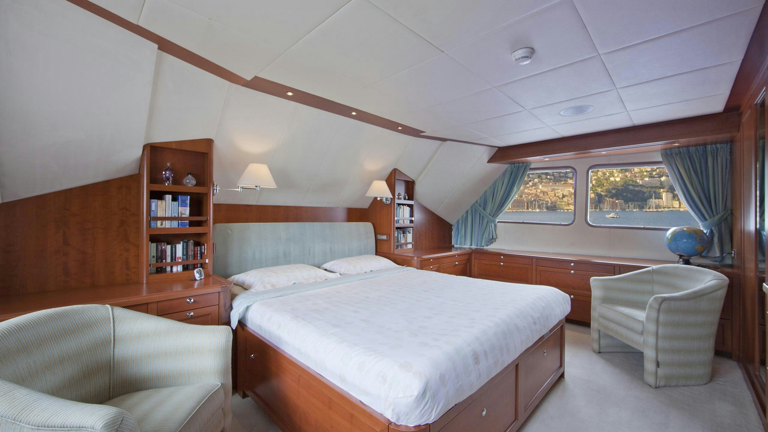 a room with a bed and a couch aboard CORNELIA Yacht for Charter