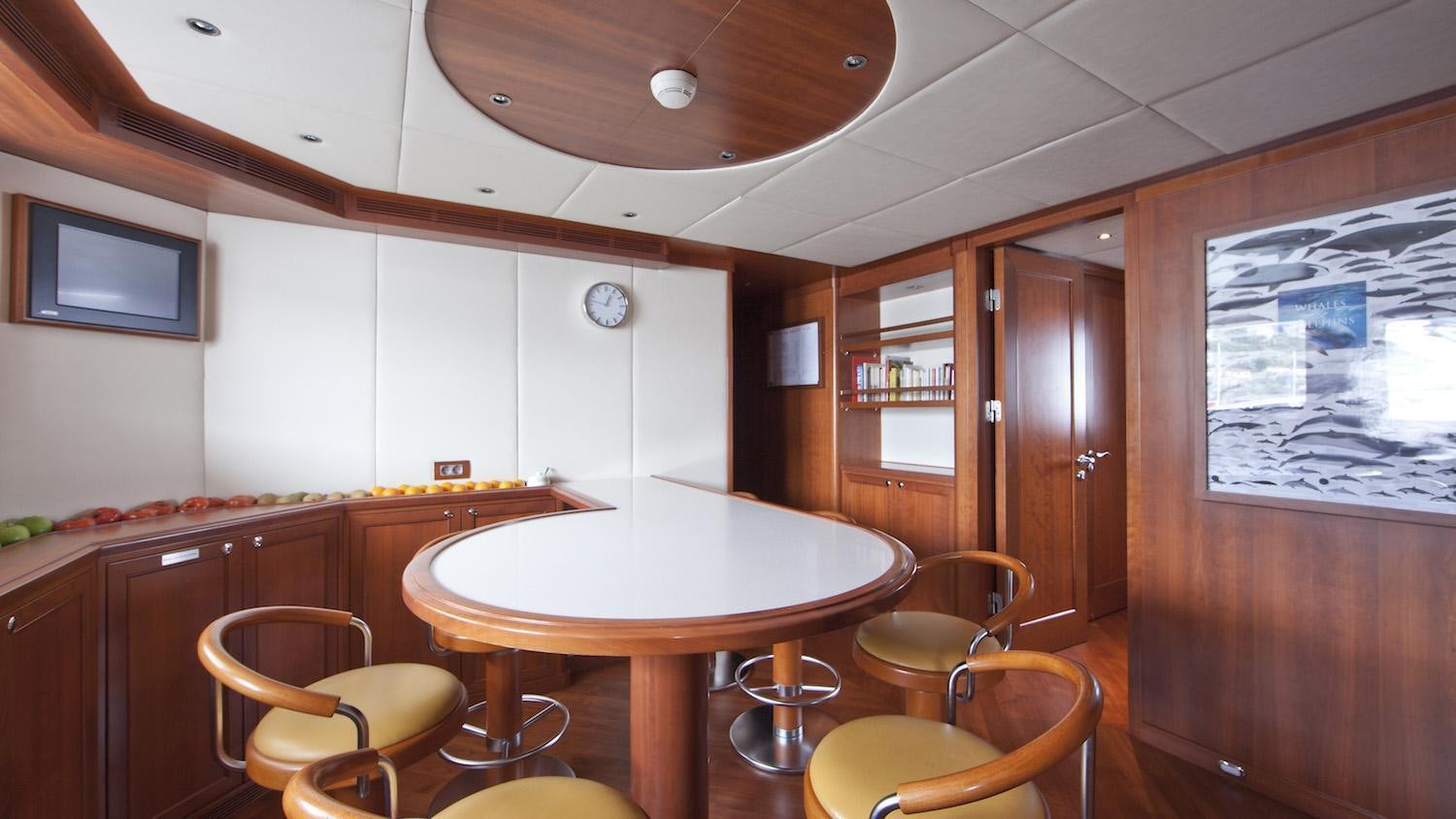a kitchen with a table and chairs aboard CORNELIA Yacht for Charter