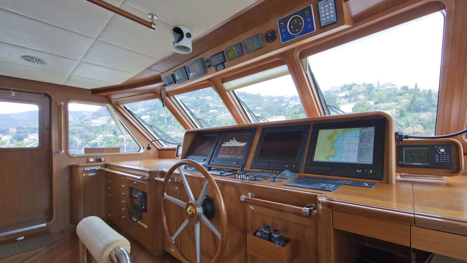 a wooden desk with computers aboard CORNELIA Yacht for Charter