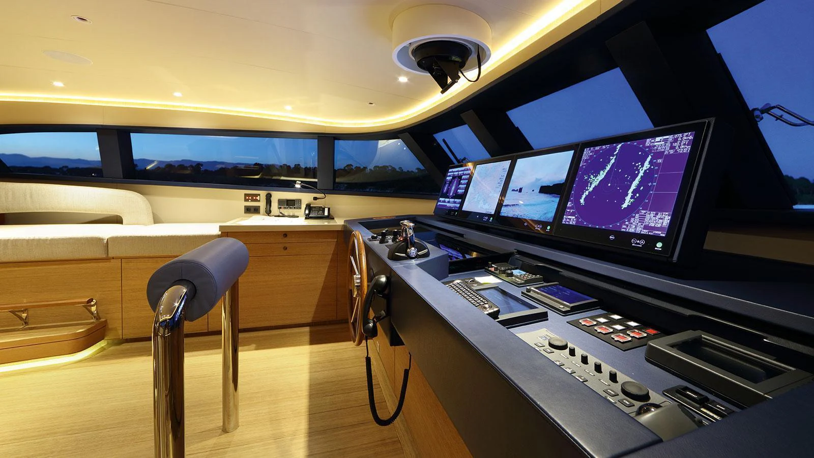 a room with a large tv and a table with chairs aboard SOLIS Yacht for Charter