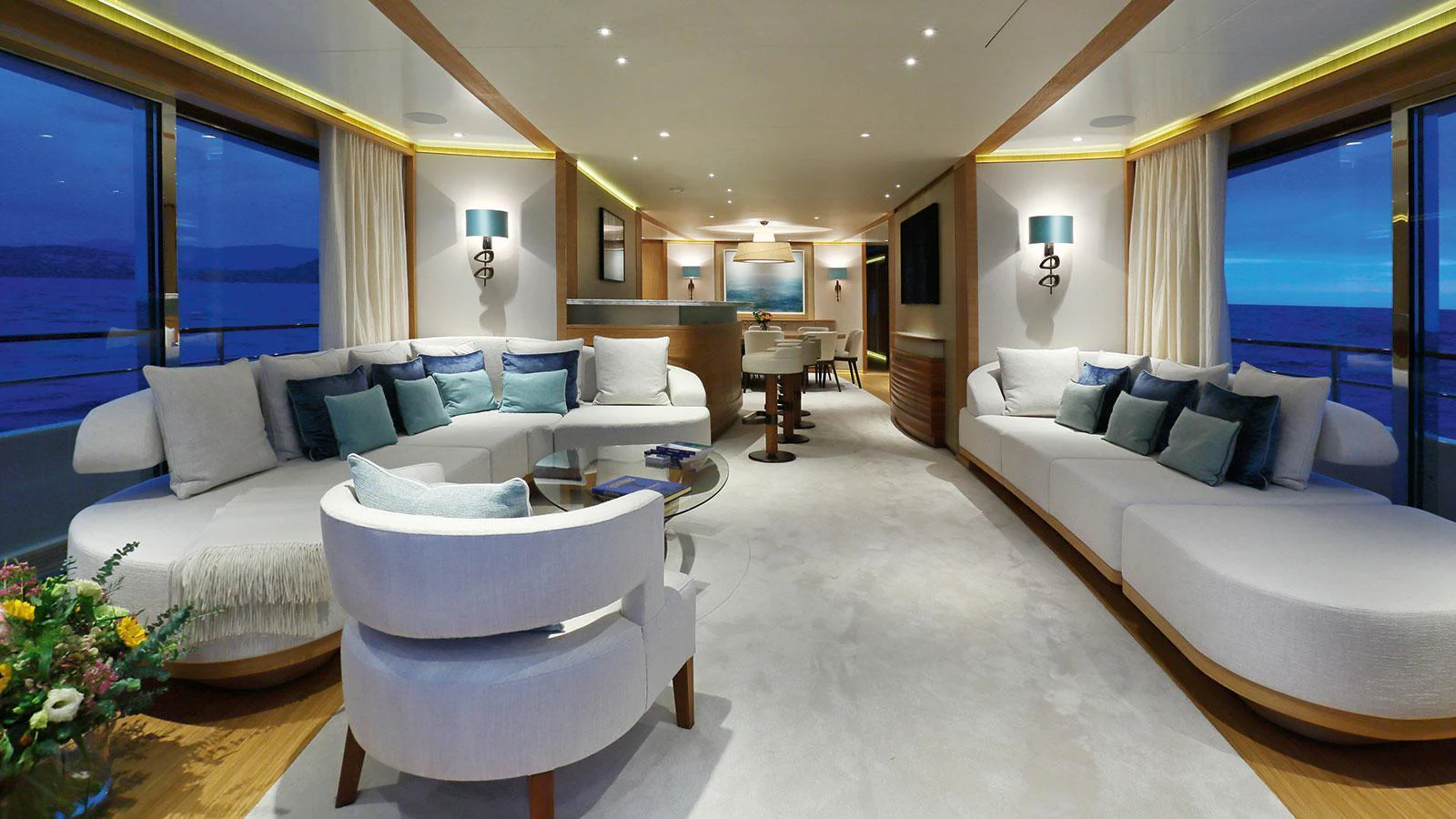 a living room with a large white couch and a large window aboard SOLIS Yacht for Charter
