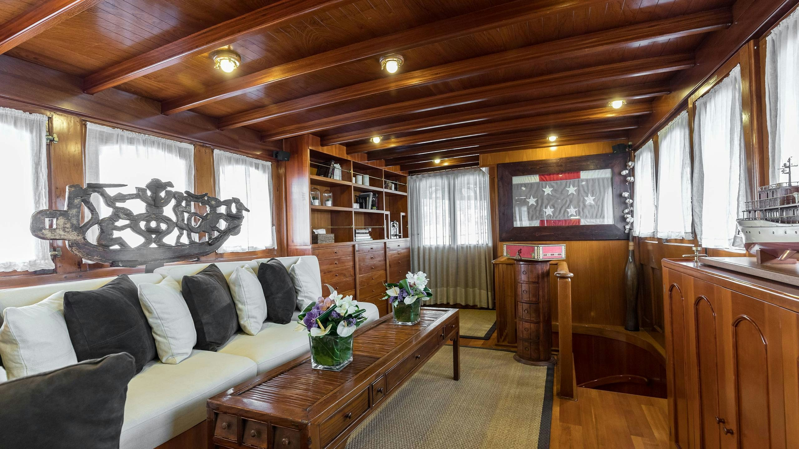 a living room with a couch and a table aboard OVER THE RAINBOW OF LONDON Yacht for Charter