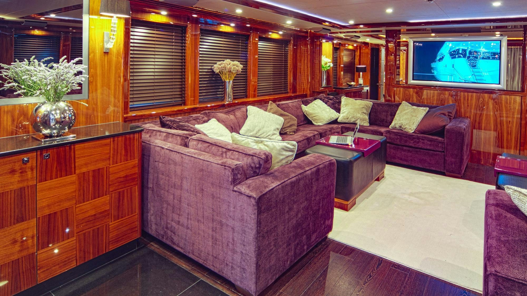 a living room with a leather couch aboard ARAGO Yacht for Charter