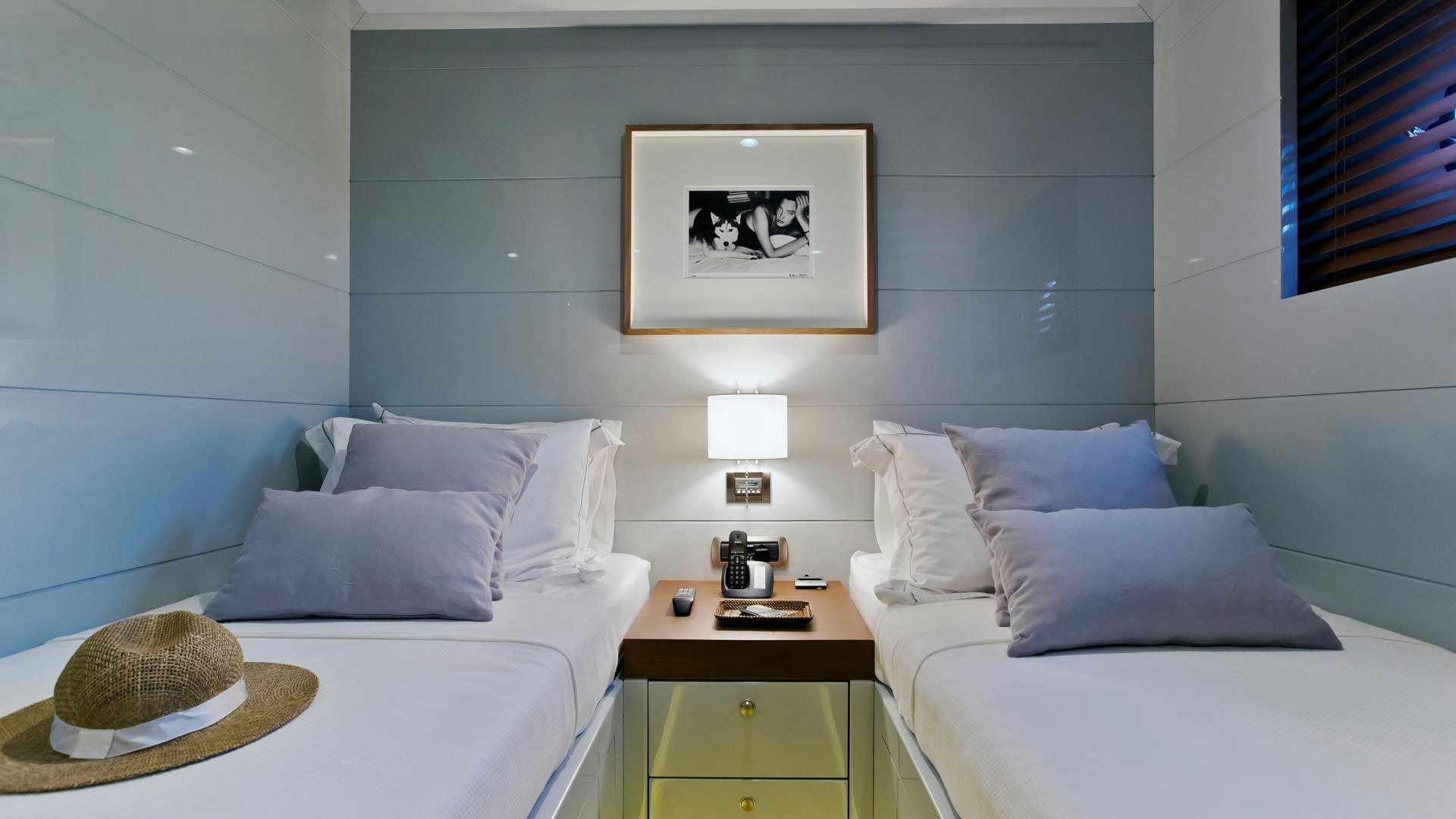 a room with a bed and a mirror aboard ONLY NOW Yacht for Charter