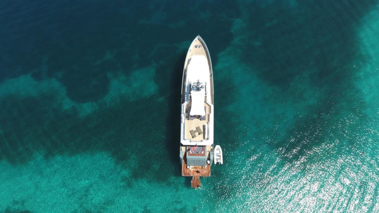 a white boat in the water aboard ONLY NOW Yacht for Charter