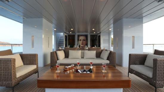 a living room with a table and chairs aboard ONLY NOW Yacht for Charter