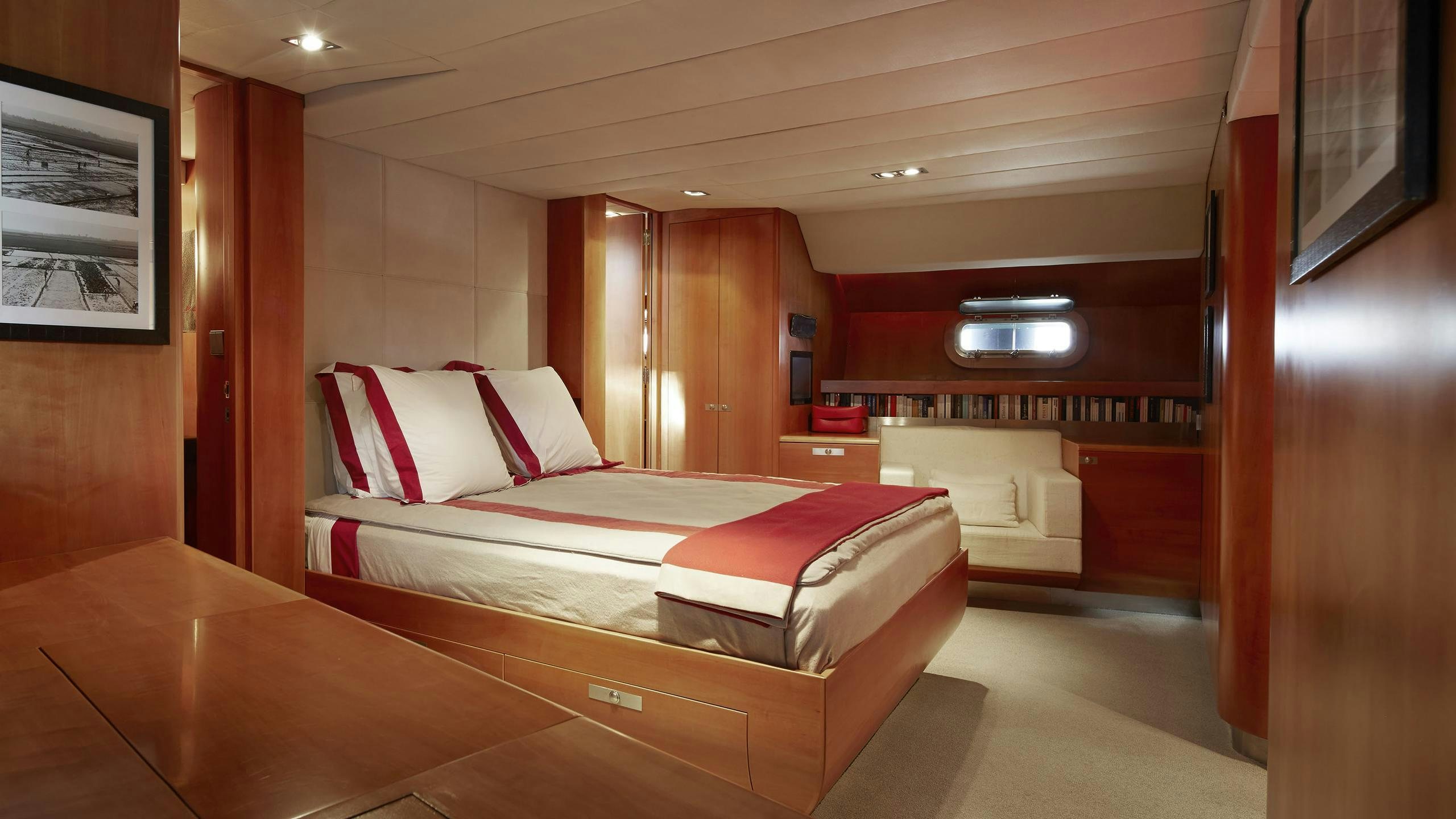 a room with a bed and a mirror aboard SILVERTIP Yacht for Charter
