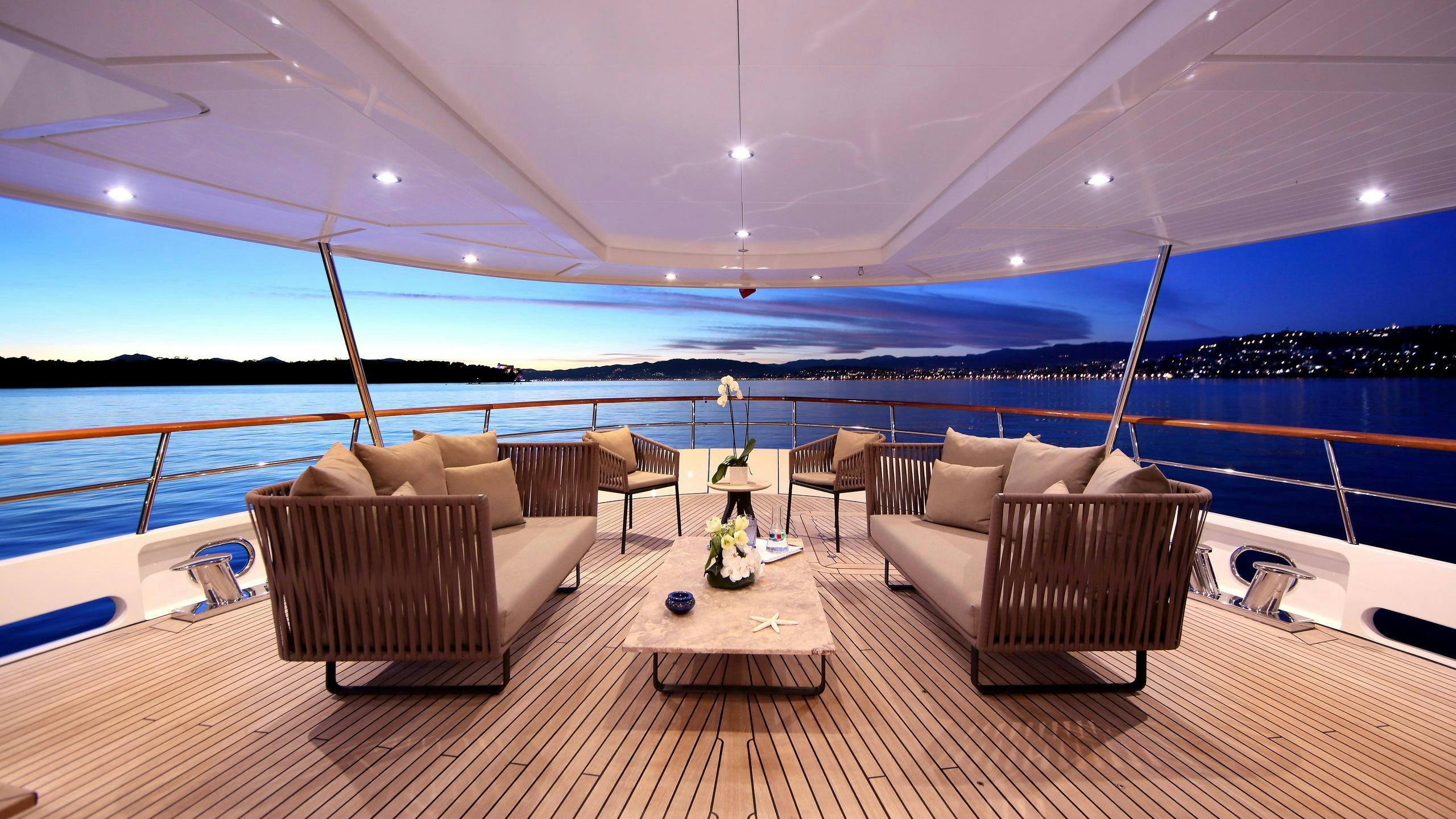 a room with a couch and a table and chairs aboard ROBBIE BOBBY Yacht for Charter