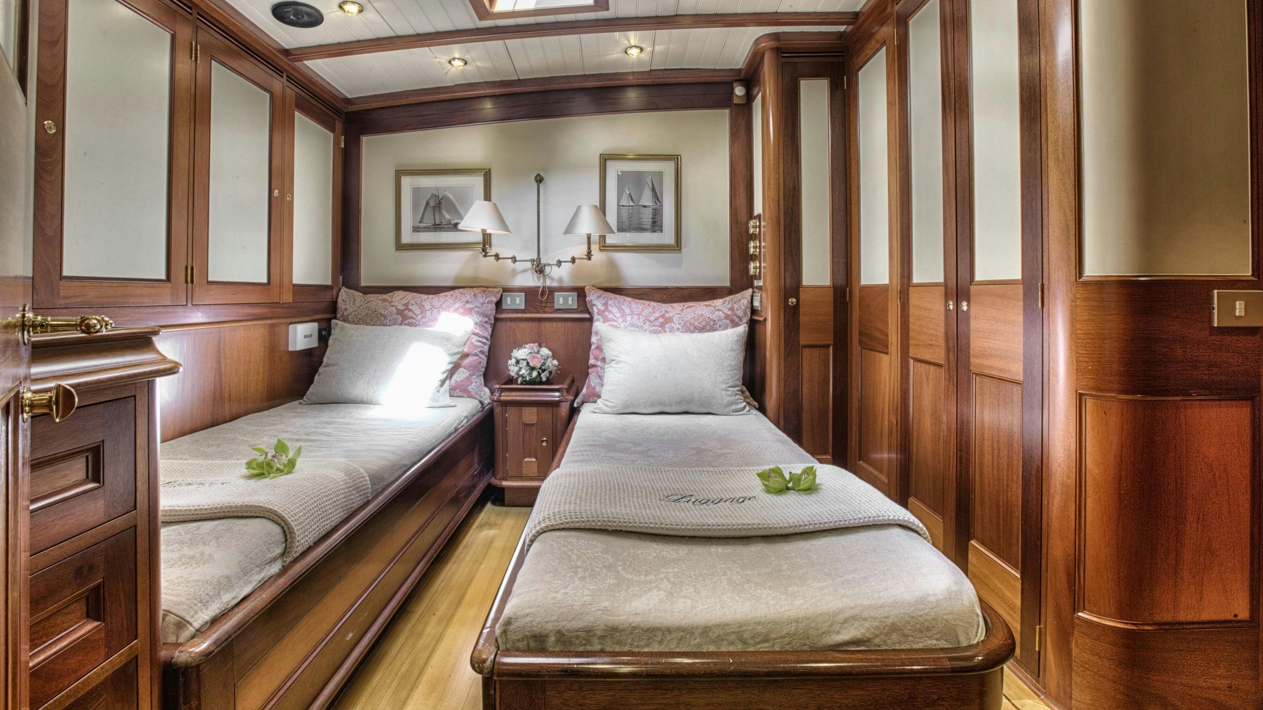 a bed with a white pillow and a wooden wall aboard SHAMOUN Yacht for Charter