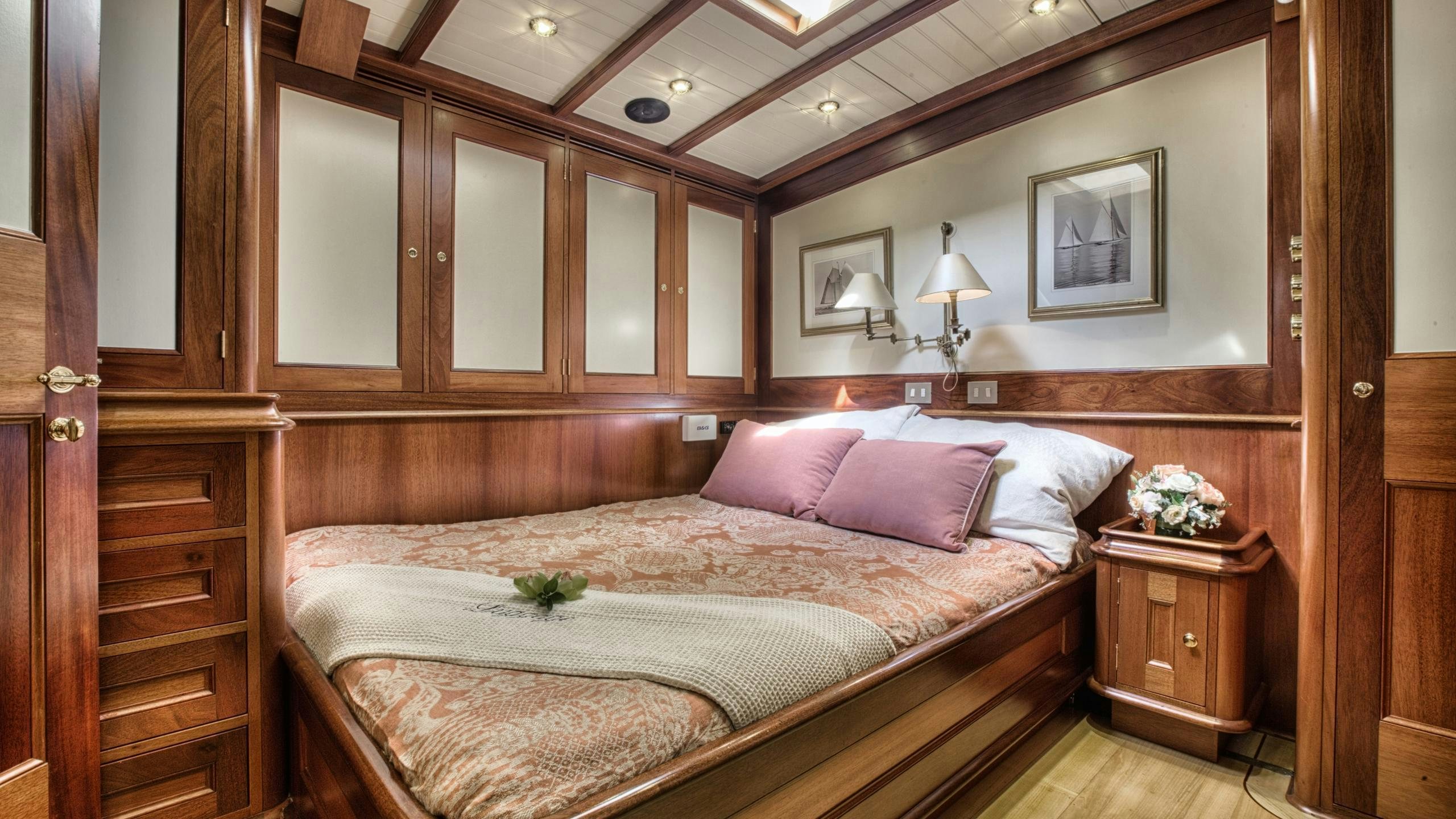 a bed with pink pillows aboard SHAMOUN Yacht for Charter