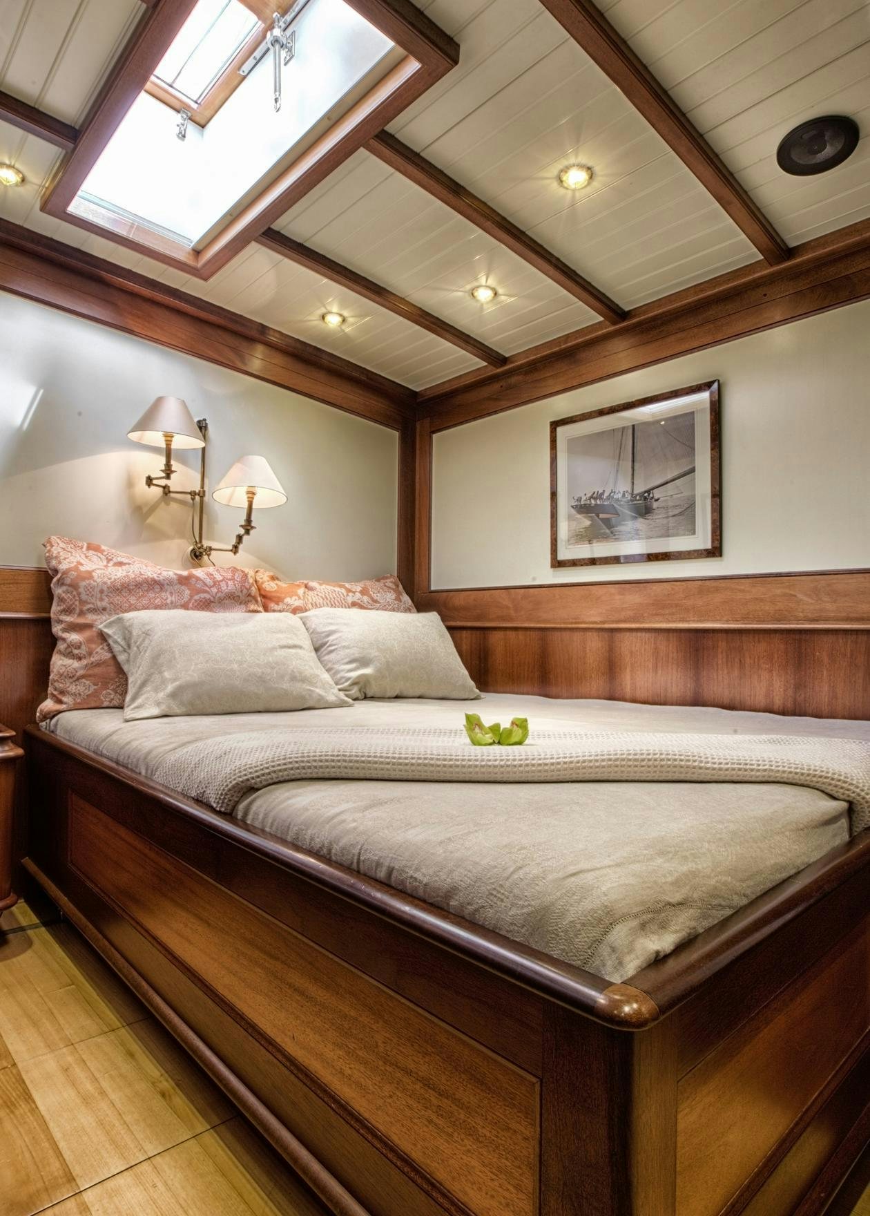 a bed with a white comforter aboard SHAMOUN Yacht for Charter