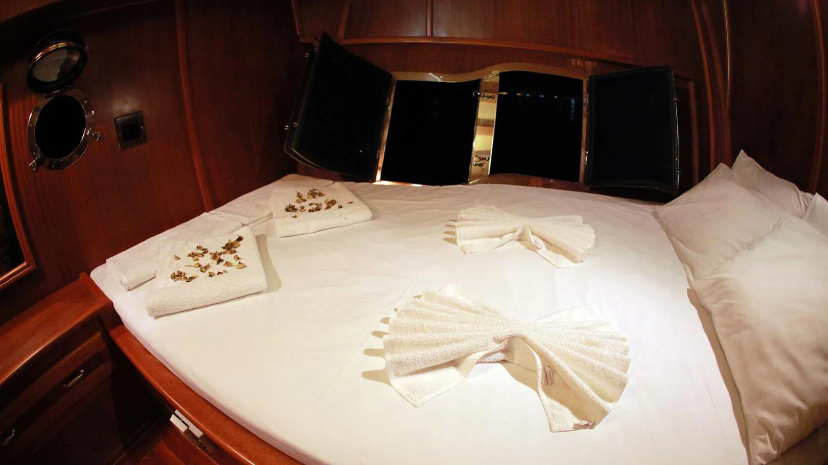 a bed with white sheets and pillows aboard JUNIOR ORCUN Yacht for Charter