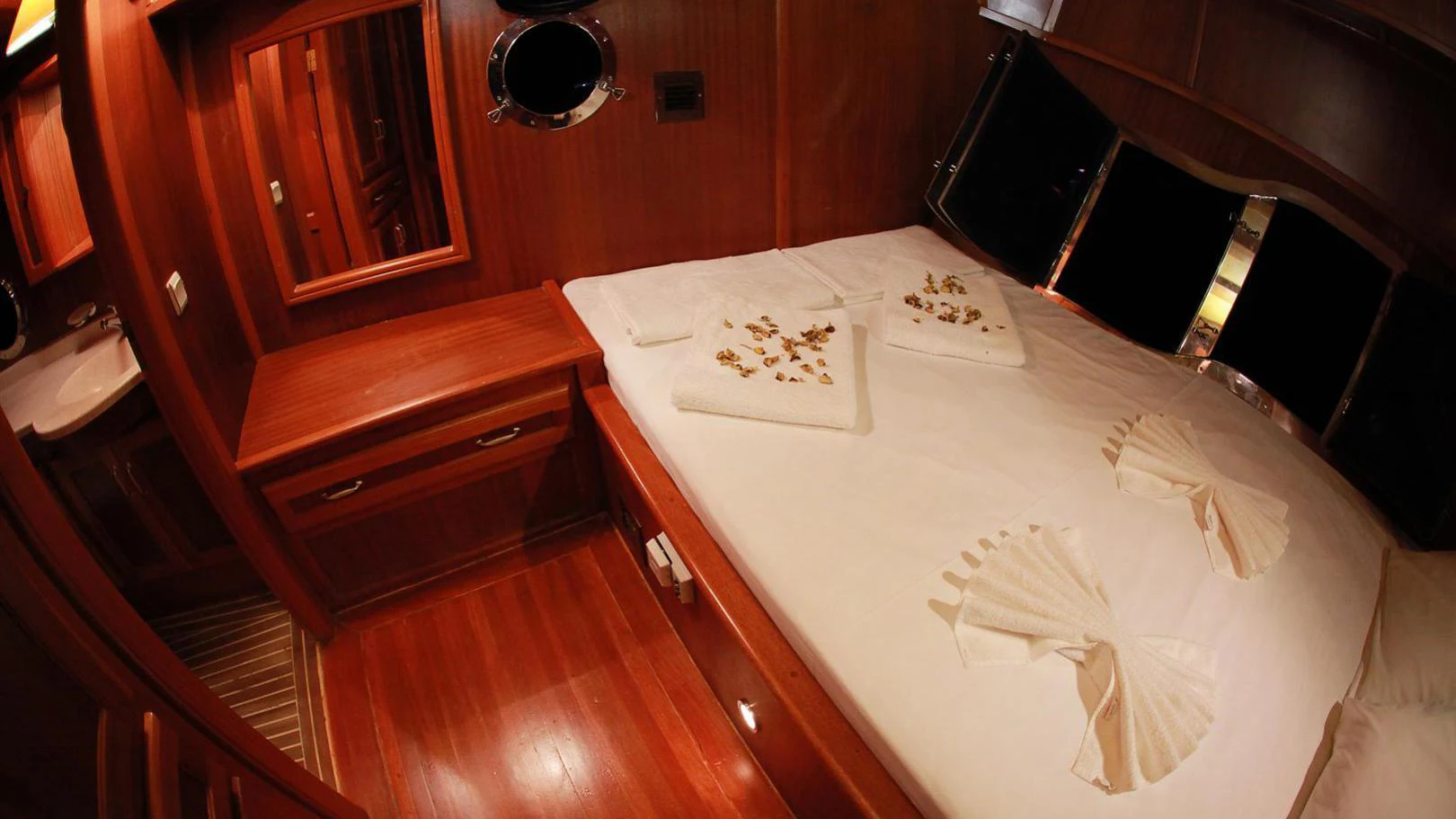 a bed with white sheets aboard JUNIOR ORCUN Yacht for Charter