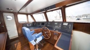 a room with a desk and a chair aboard PERSUADER Yacht for Charter