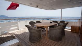 a table and chairs on a deck aboard PERSUADER Yacht for Charter