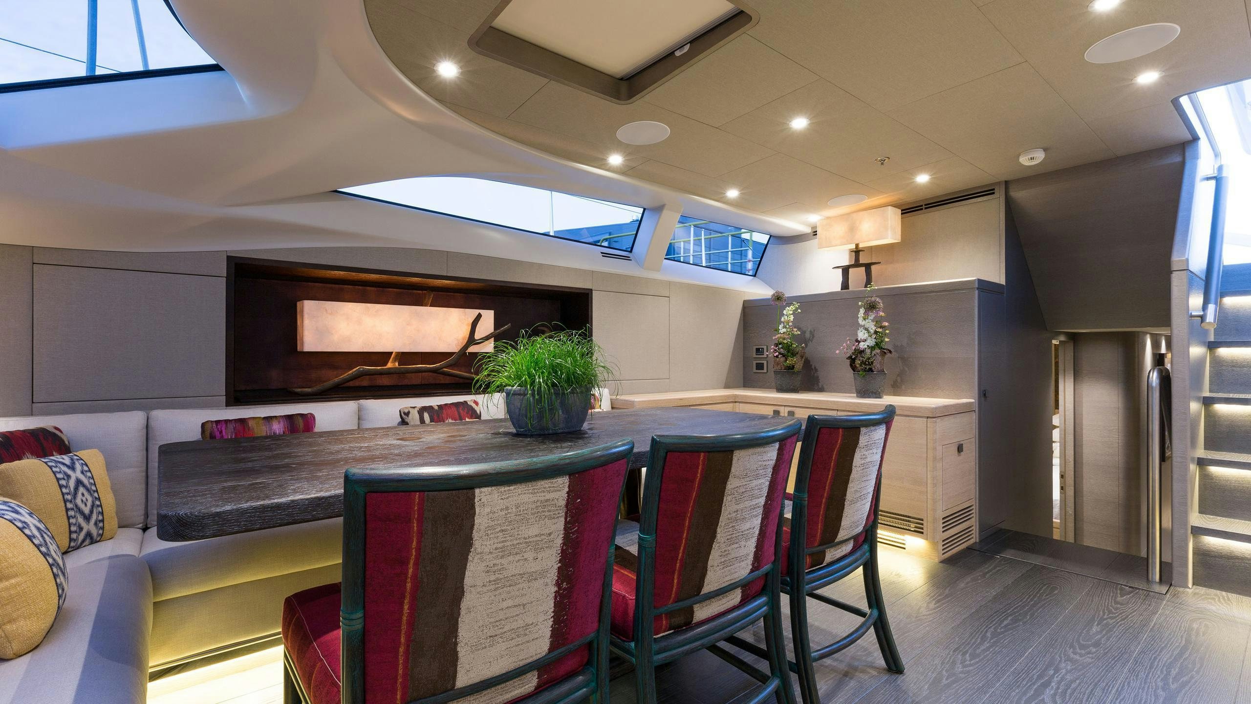 a living room with a table and chairs aboard INUKSHUK Yacht for Charter