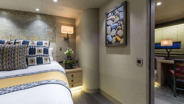 a bedroom with a bed and a desk aboard INUKSHUK Yacht for Charter