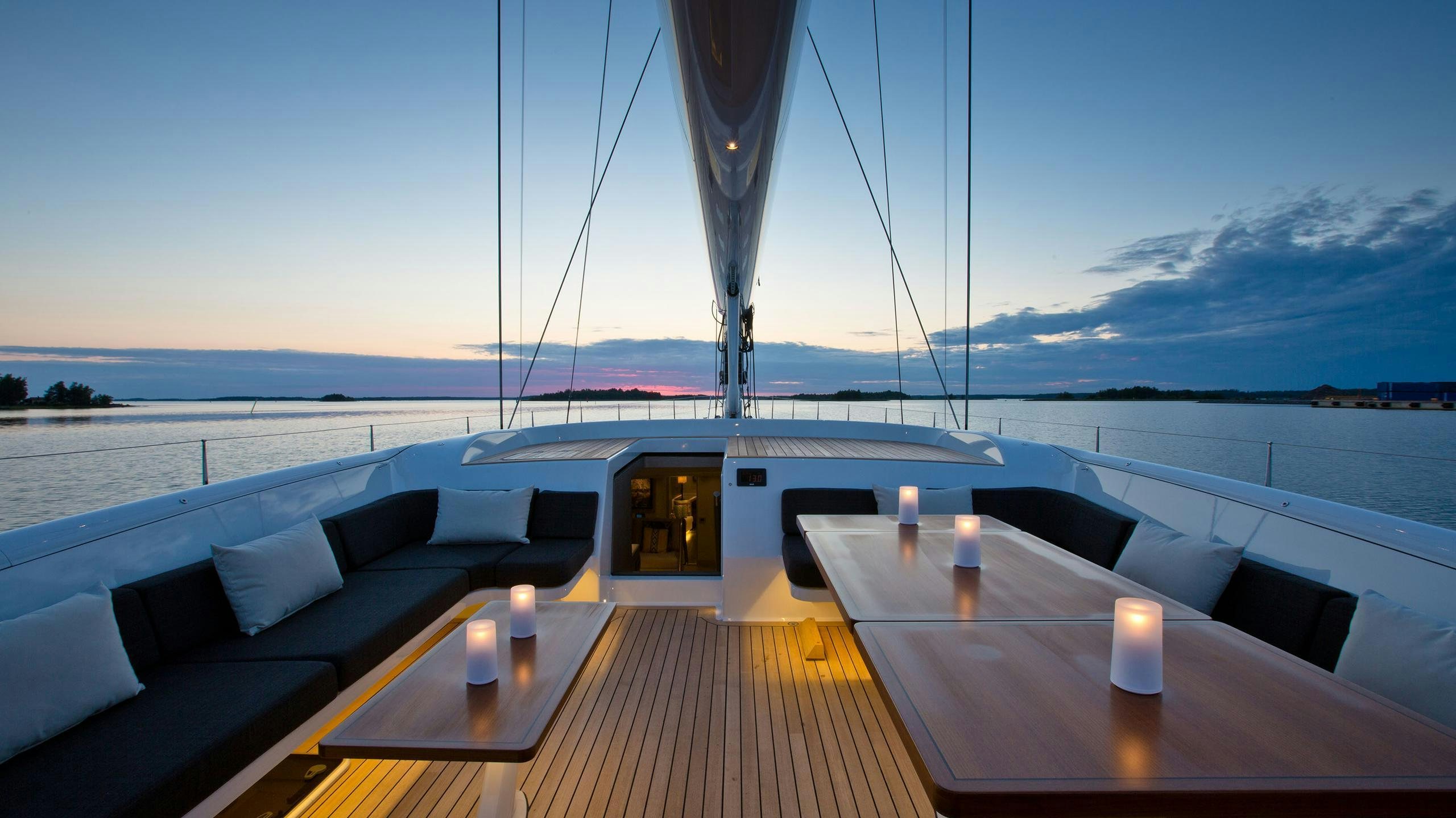 a deck with a table and candles on it aboard INUKSHUK Yacht for Charter