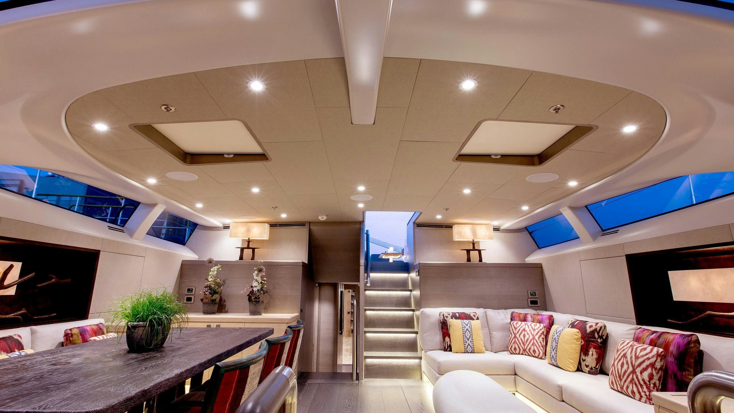 a living room with a staircase and a large window aboard INUKSHUK Yacht for Charter