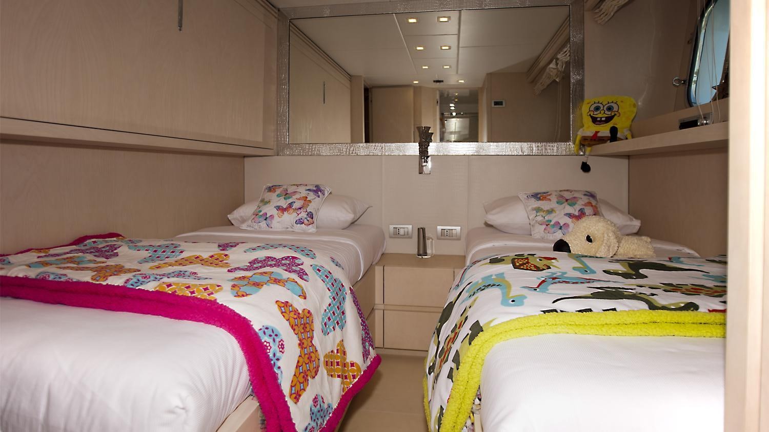 a couple of beds in a room aboard TUSCAN SUN Yacht for Charter
