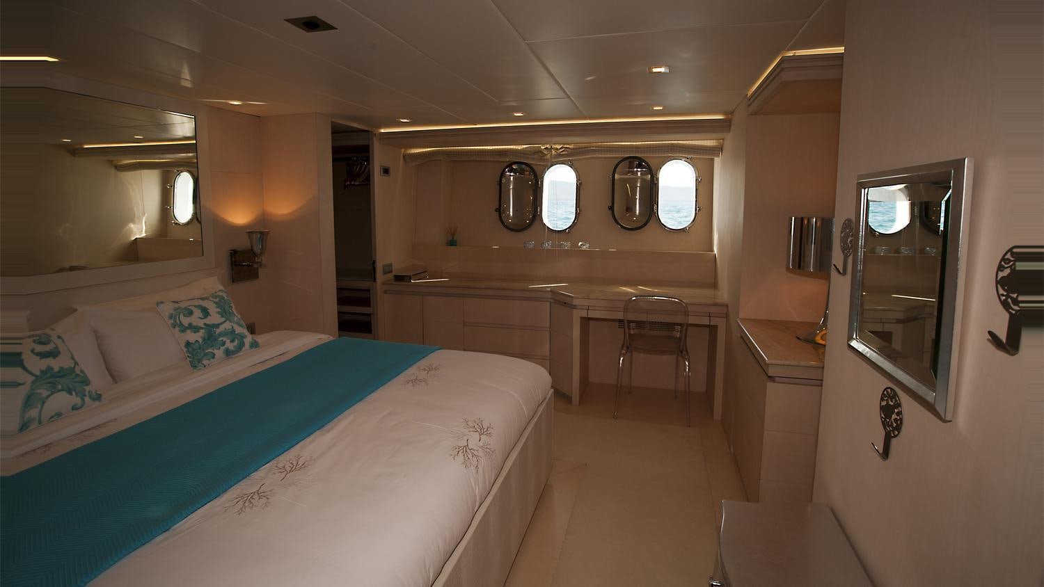 a room with a bed and a table aboard TUSCAN SUN Yacht for Charter