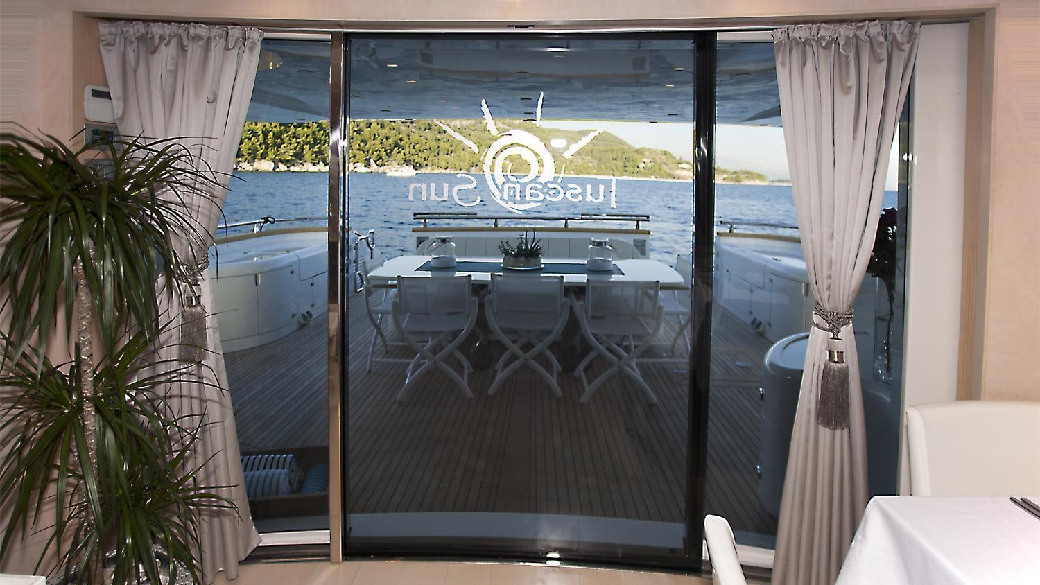 a table with chairs and a plant aboard TUSCAN SUN Yacht for Charter