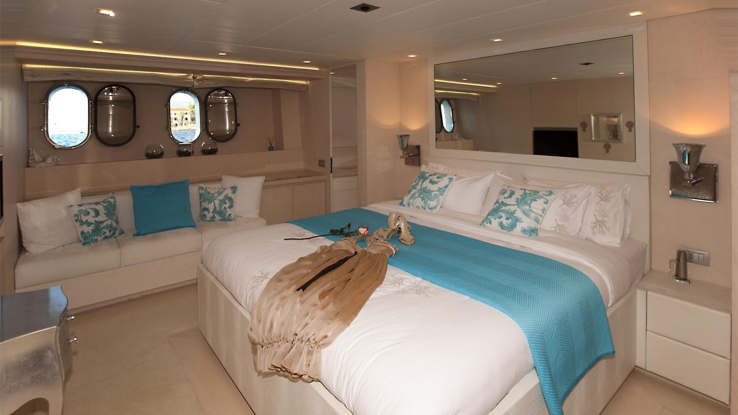 a room with a bed and a mirror aboard TUSCAN SUN Yacht for Charter