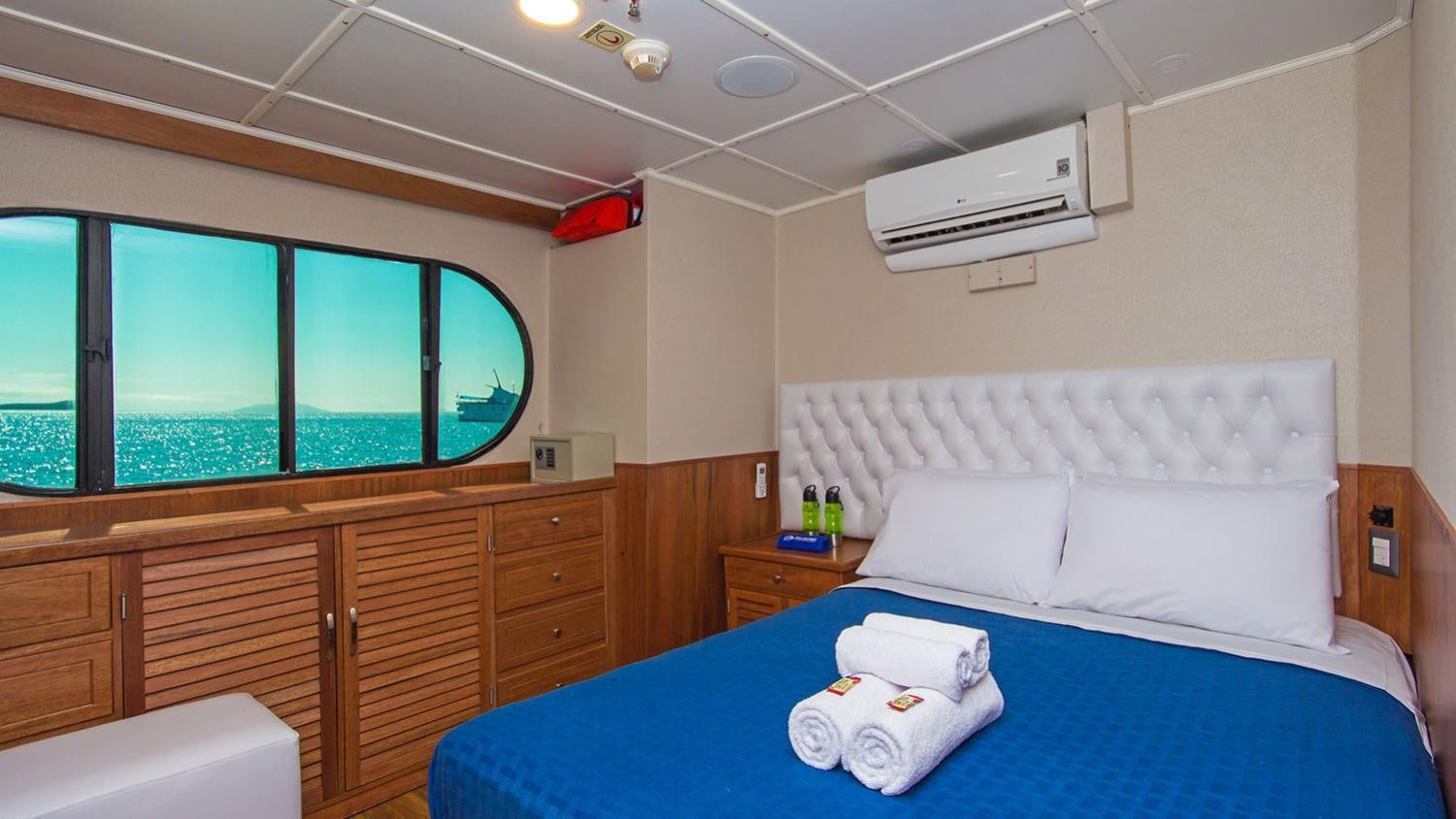 a room with a bed and a window aboard TIP TOP II Yacht for Charter
