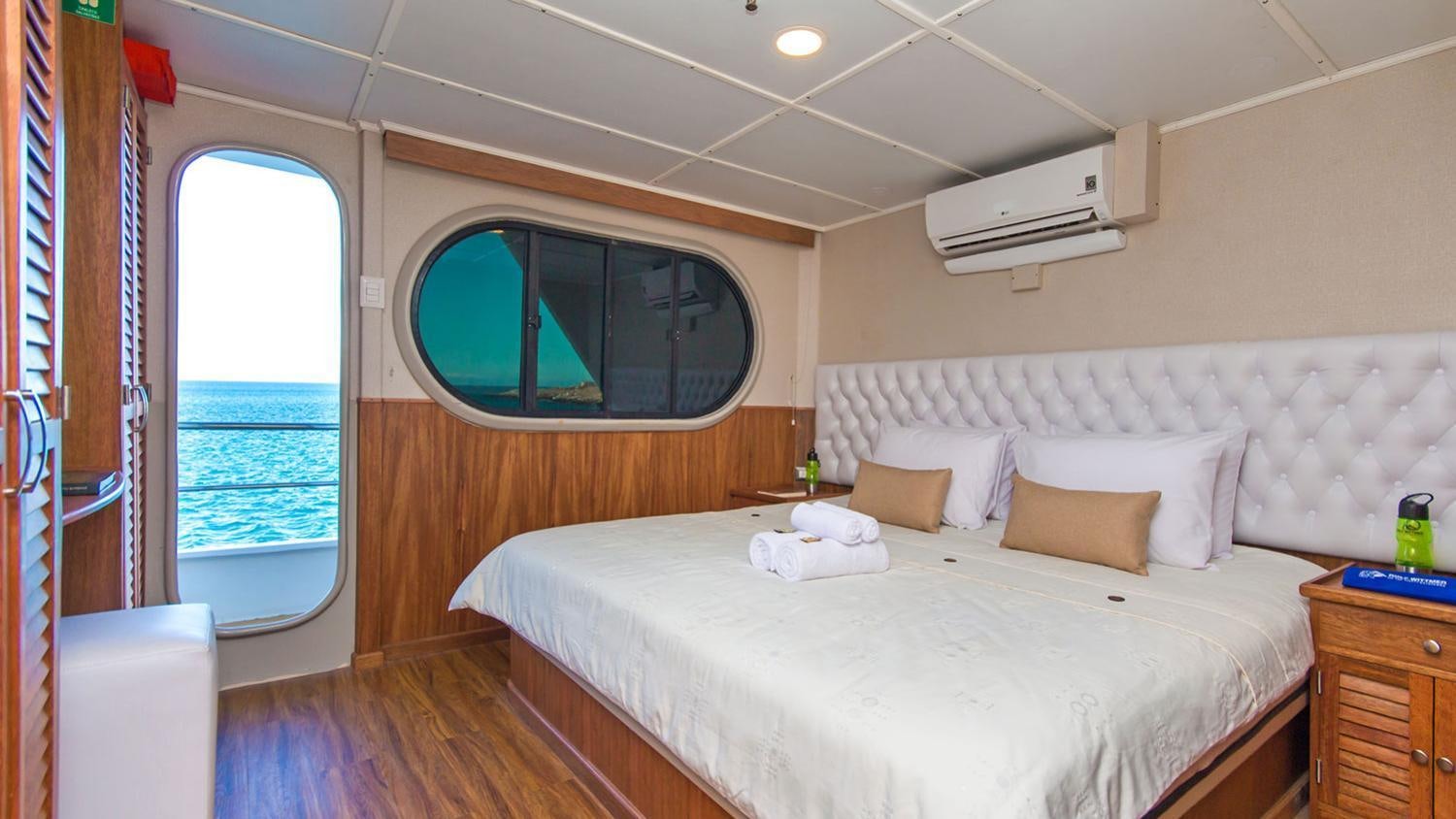 a room with a bed and a window aboard TIP TOP II Yacht for Charter