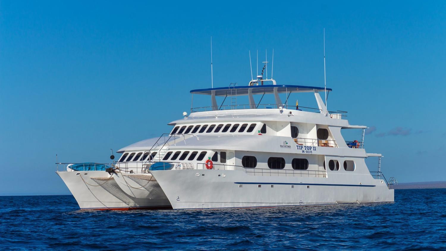 a large white boat in the water aboard TIP TOP II Yacht for Charter