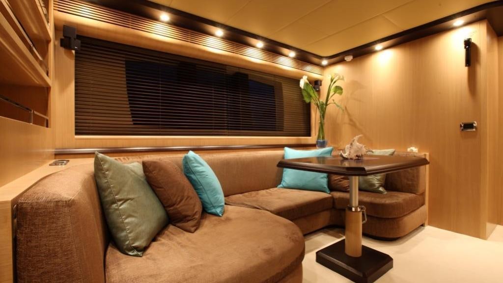 a living room with a couch and a coffee table aboard DOLCE VITA IV Yacht for Charter