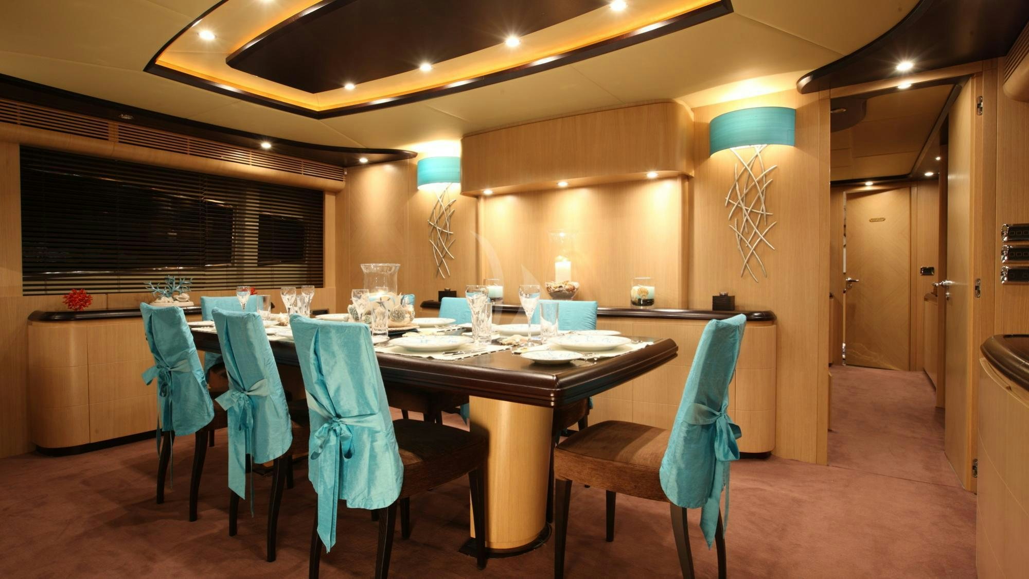 a dining room with a table and chairs aboard DOLCE VITA IV Yacht for Charter