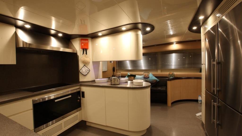 a kitchen with a stove and refrigerator aboard KIRIOS Yacht for Charter