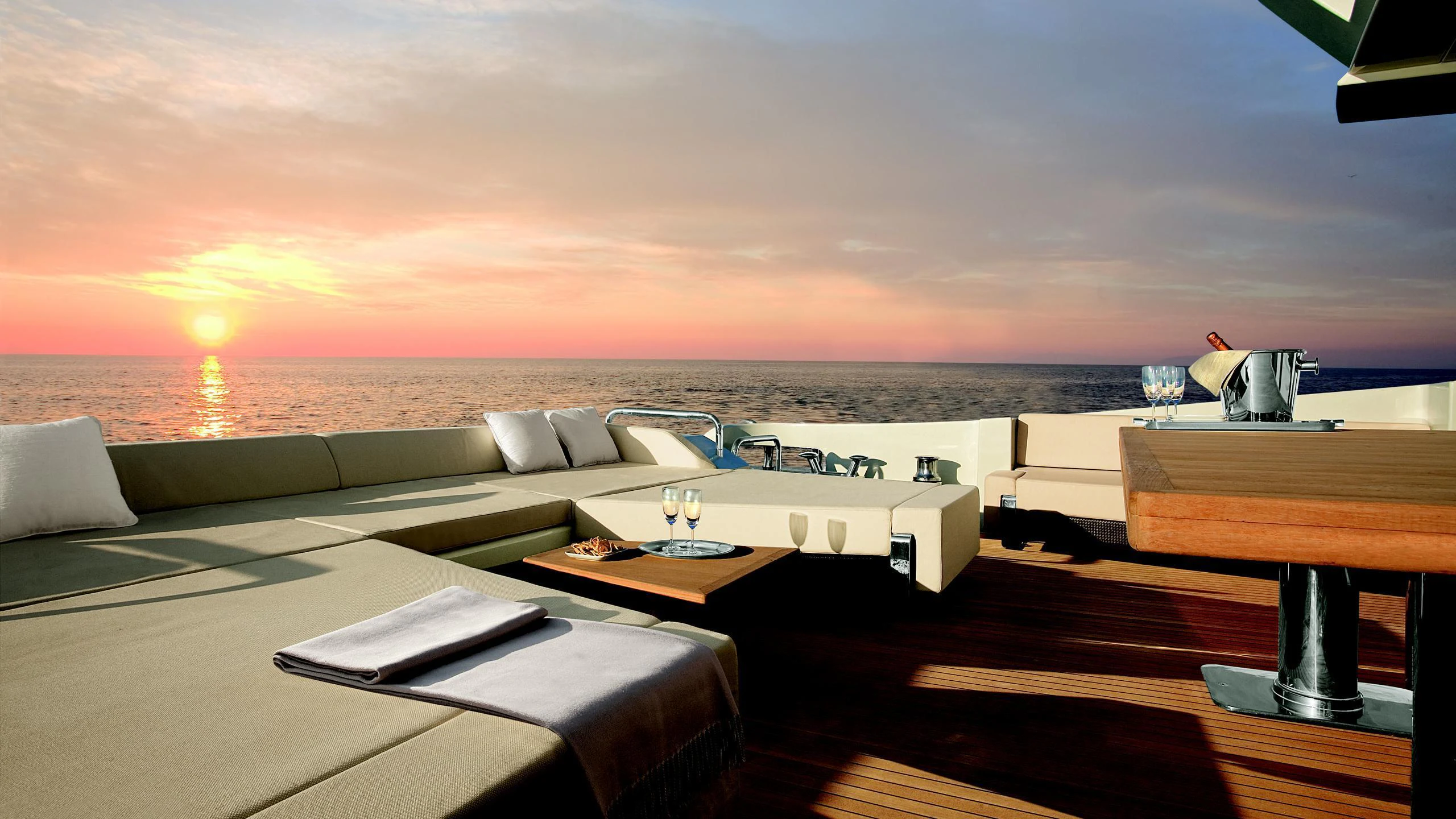 a room with a view of the ocean and a sunset aboard DUKE Yacht for Charter