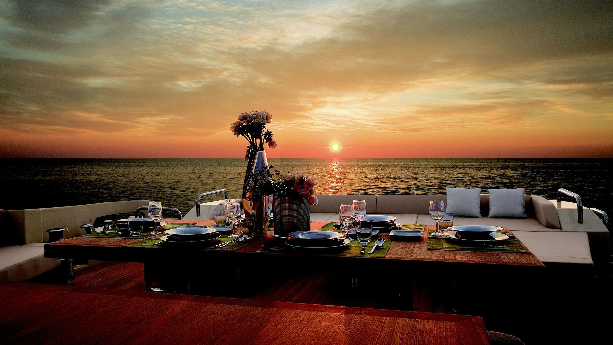 a table with a vase of flowers on it aboard DUKE Yacht for Charter