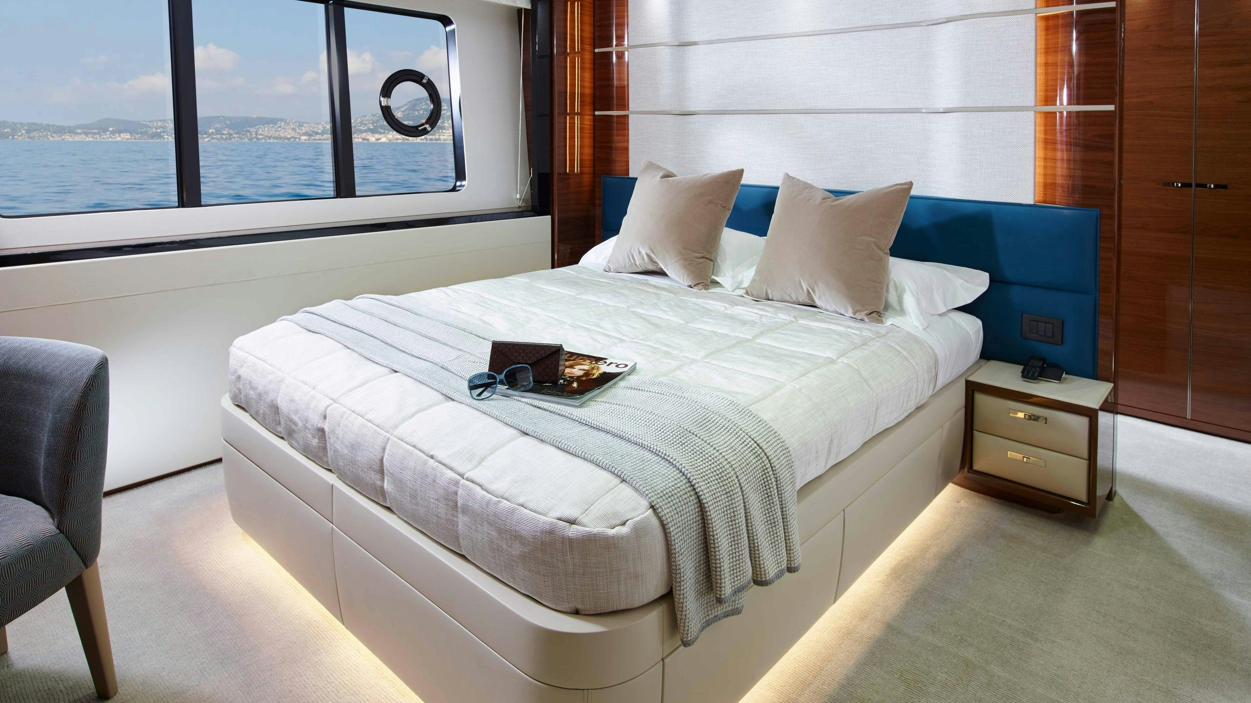 a bed with white sheets aboard KOHUBA Yacht for Charter