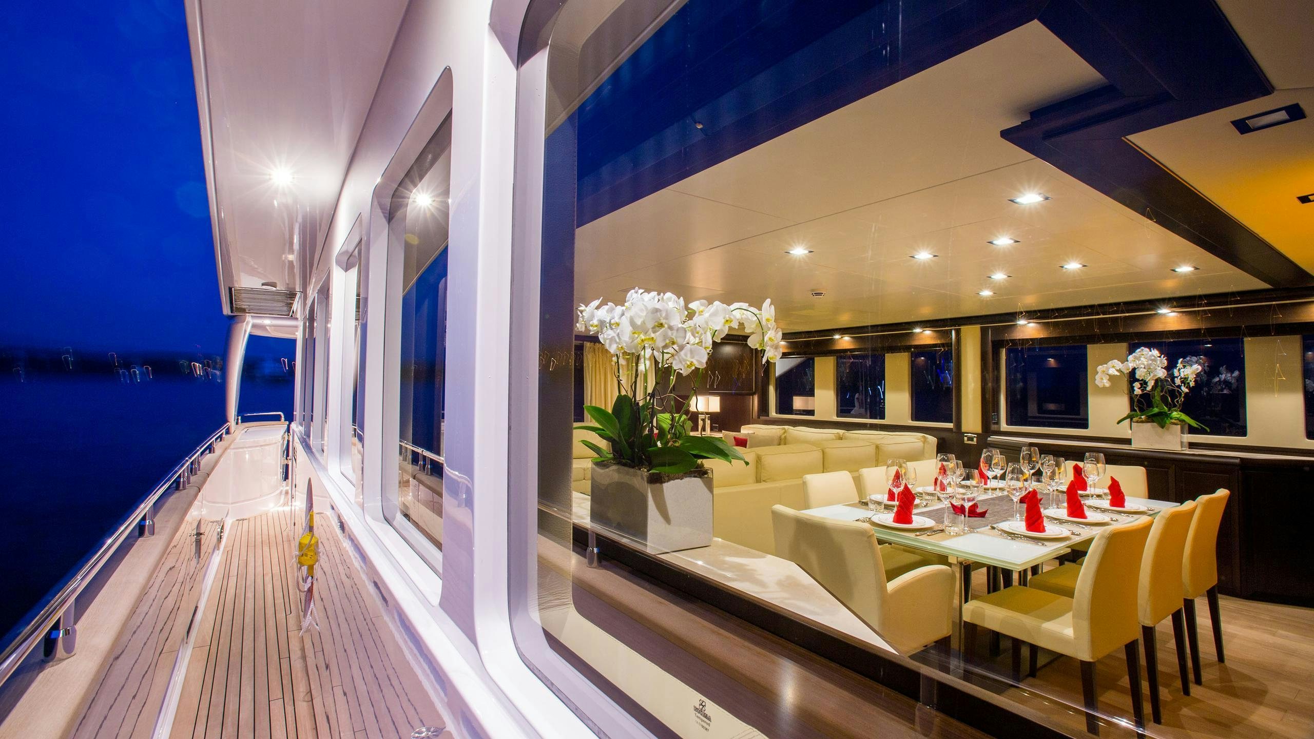 a room with tables and chairs aboard GATSBY Yacht for Charter
