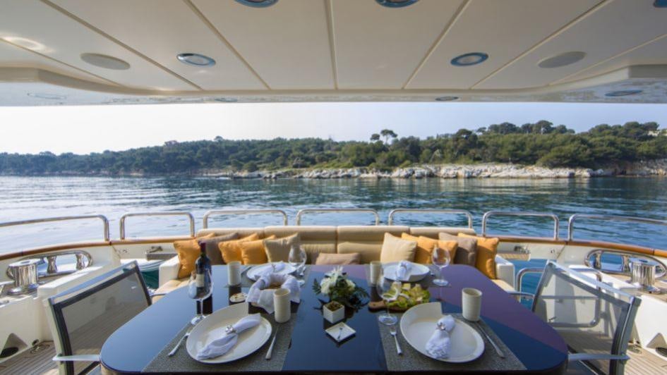 a table set for a dinner on a boat aboard QUID PRO QUO Yacht for Charter