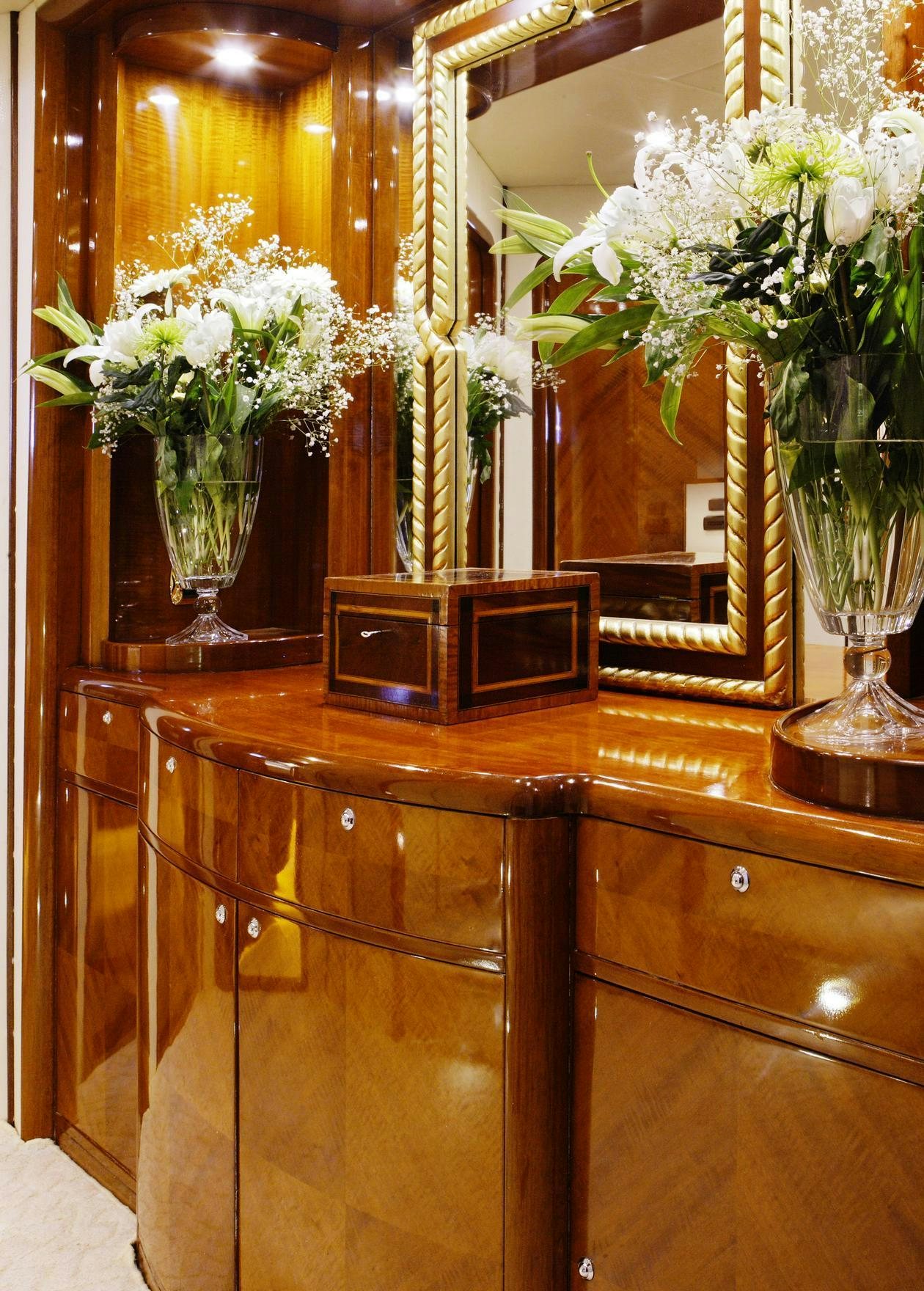 a table with flowers in a room aboard DREAM B Yacht for Charter