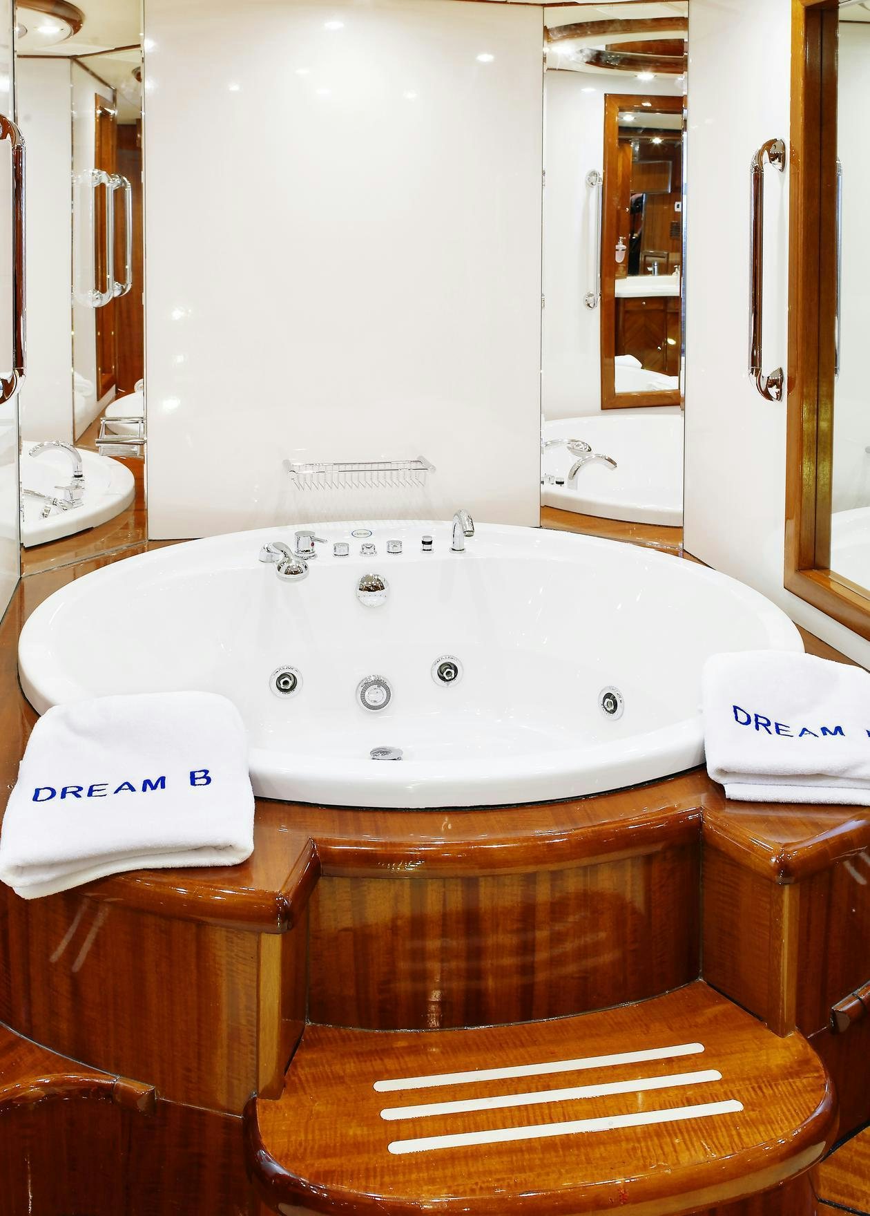a bathroom sink with a mirror aboard DREAM B Yacht for Charter
