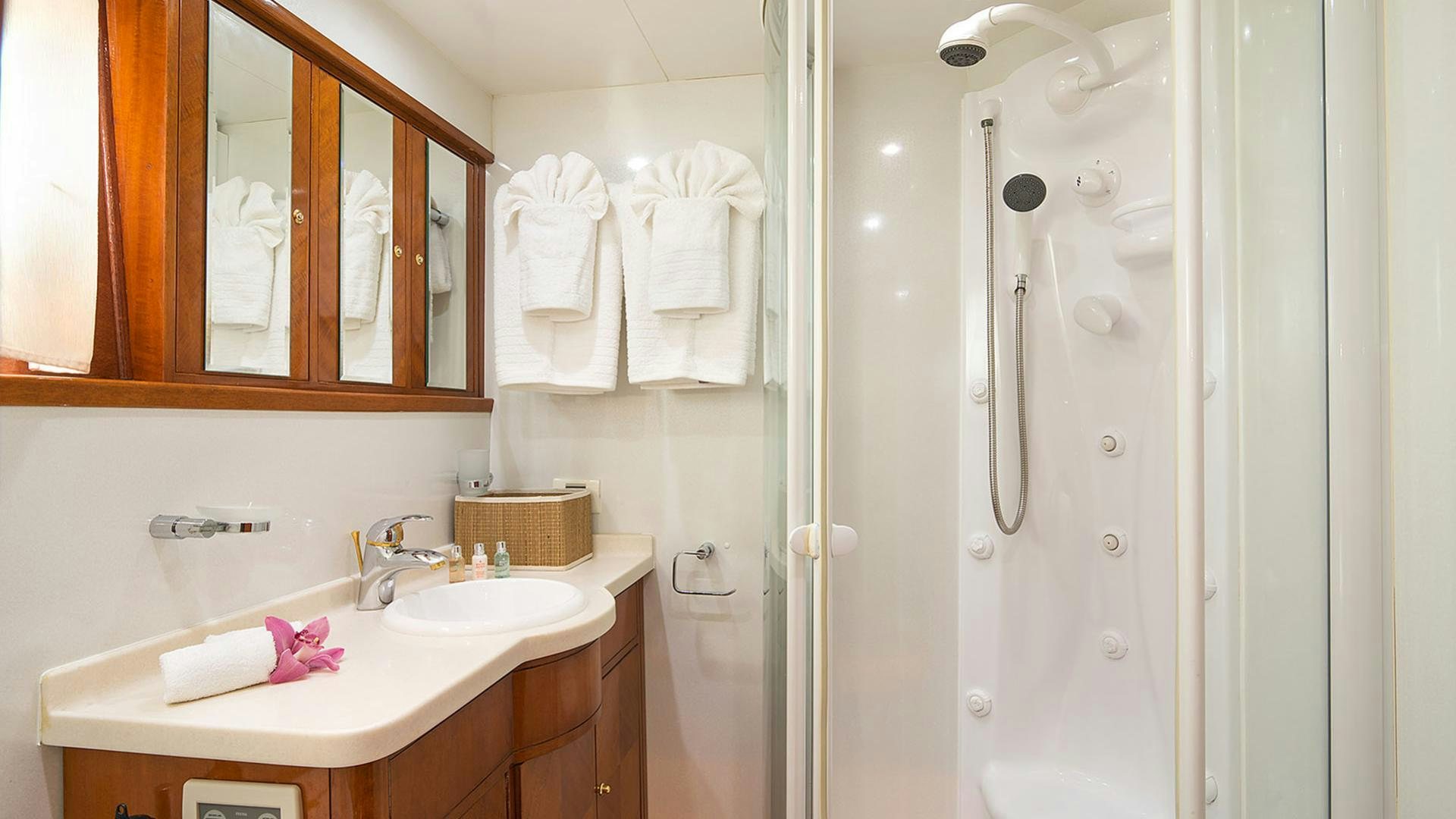 a bathroom with a shower unit and sink aboard DREAM B Yacht for Charter