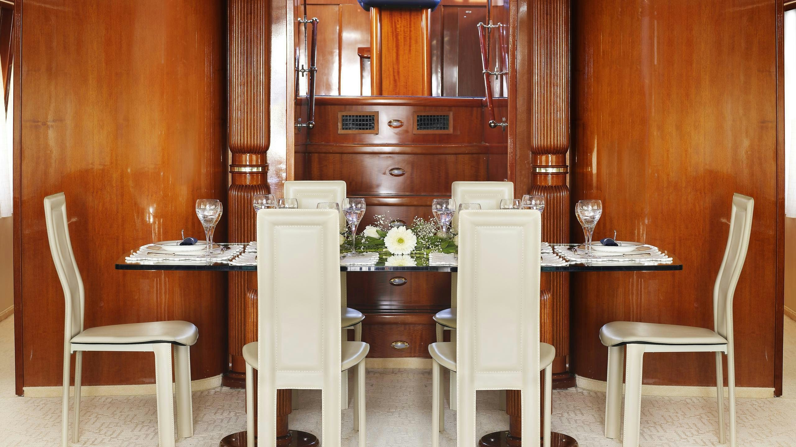 a dining room with a table and chairs aboard DREAM B Yacht for Charter