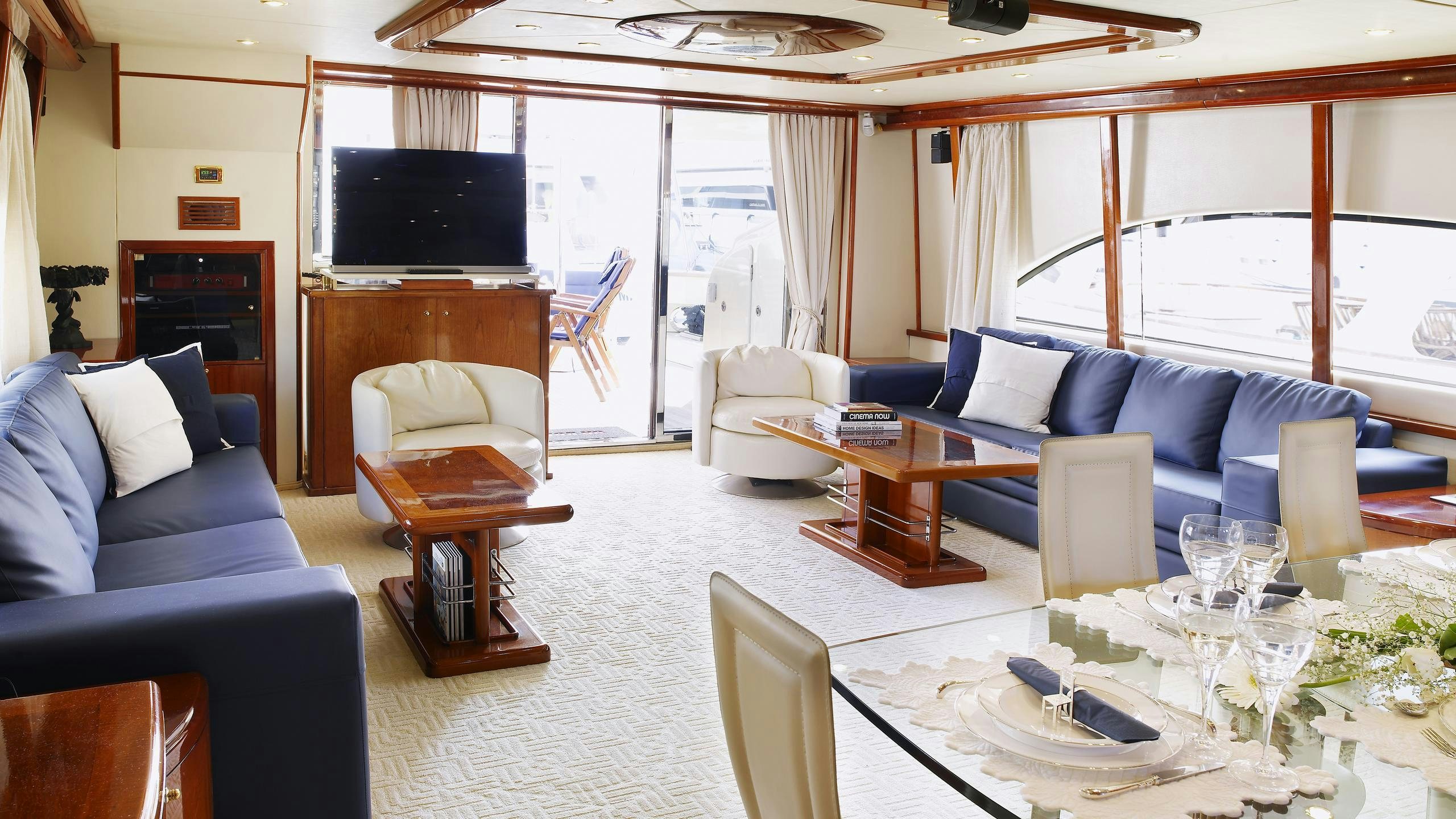 a living room with a large screen aboard DREAM B Yacht for Charter