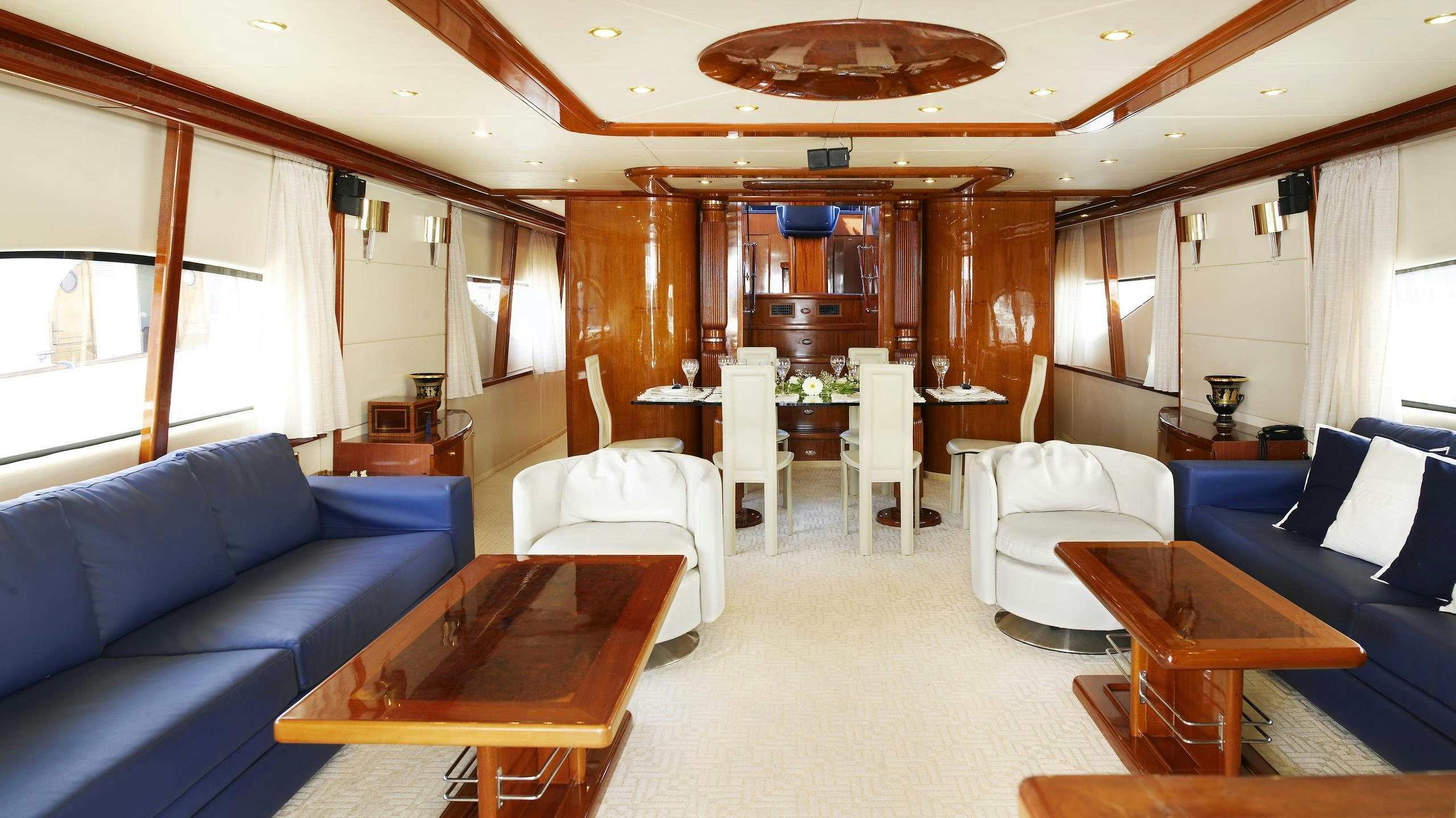 a living room with a table and chairs aboard DREAM B Yacht for Charter